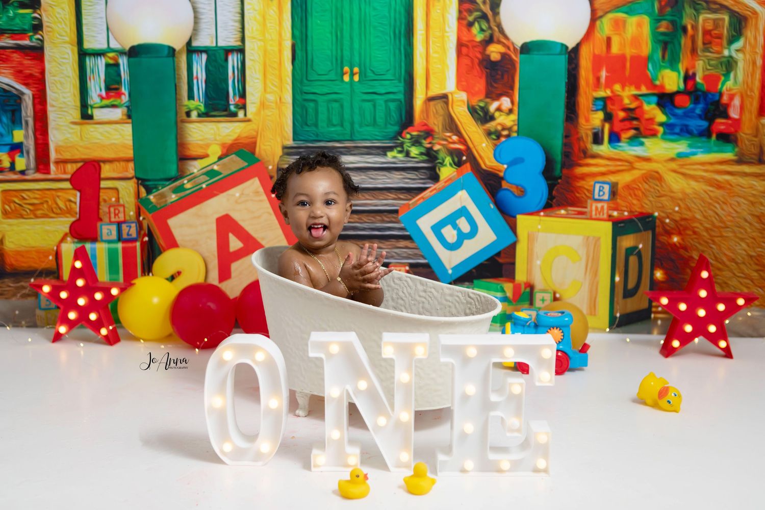 Sesame street first birthday. Baby boy in bathtub clapping hands