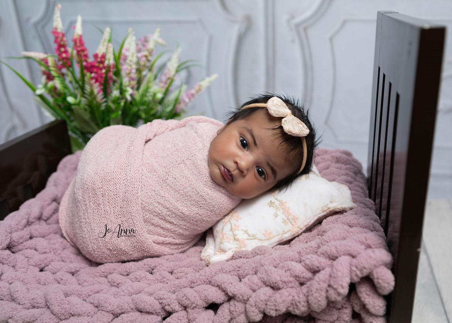 Newborn baby wide awake in baby bed