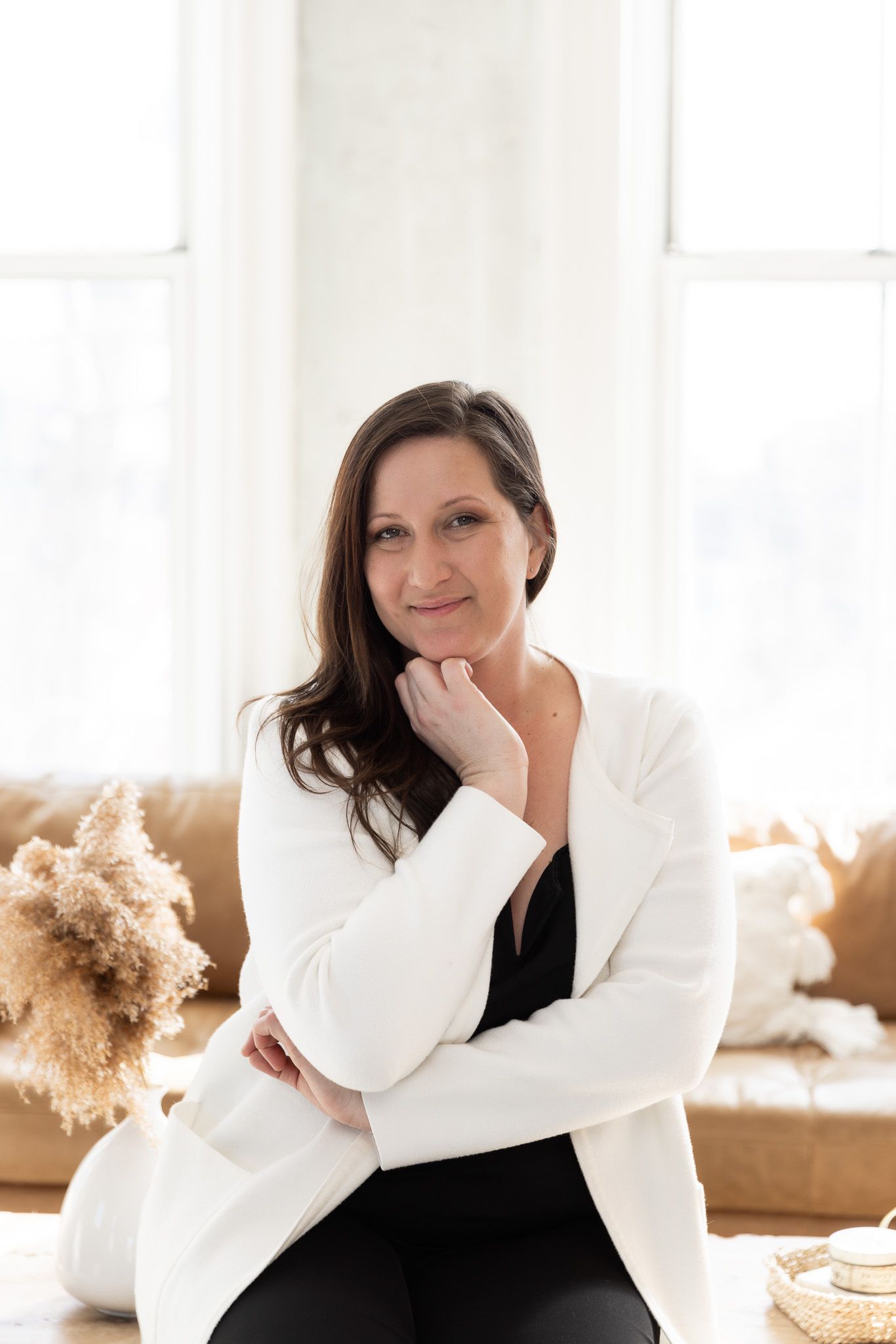 Business portraits featuring black and white professional attire in sunlit room.