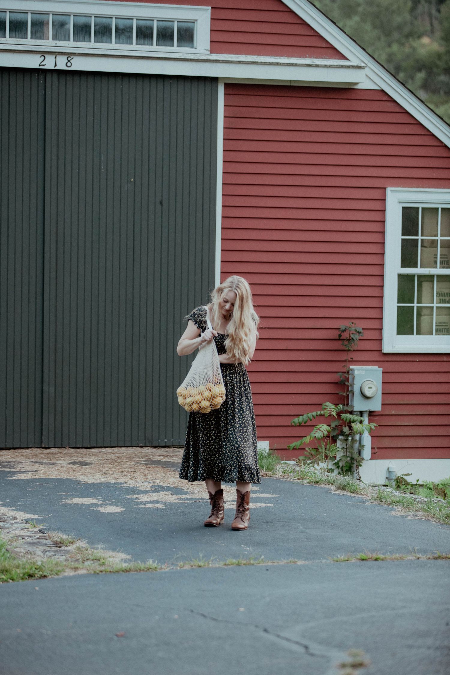 Sequential shots of a floral dress against a red barn building exterior.