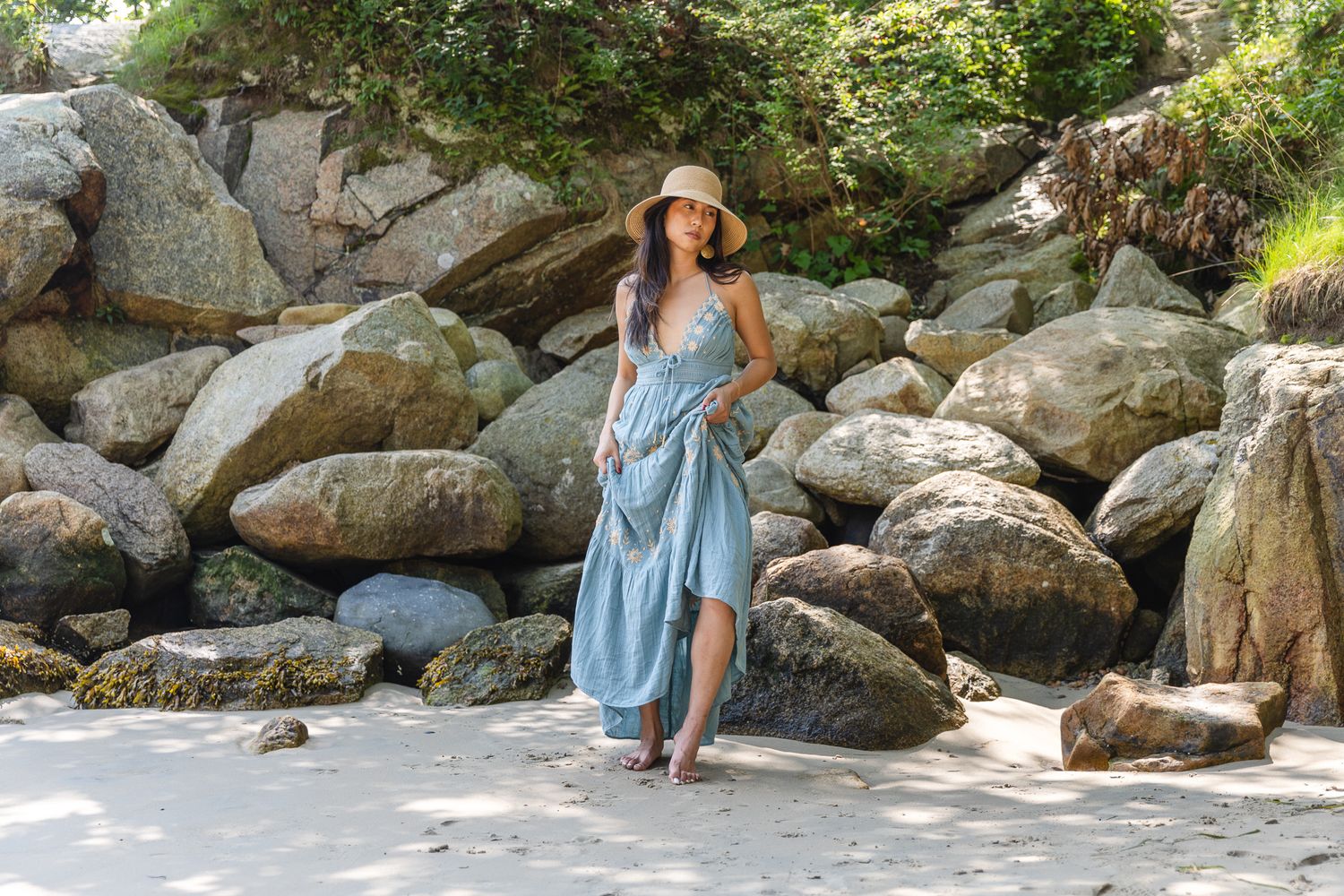 Natural light portrait session among large rocky formations outdoors.
