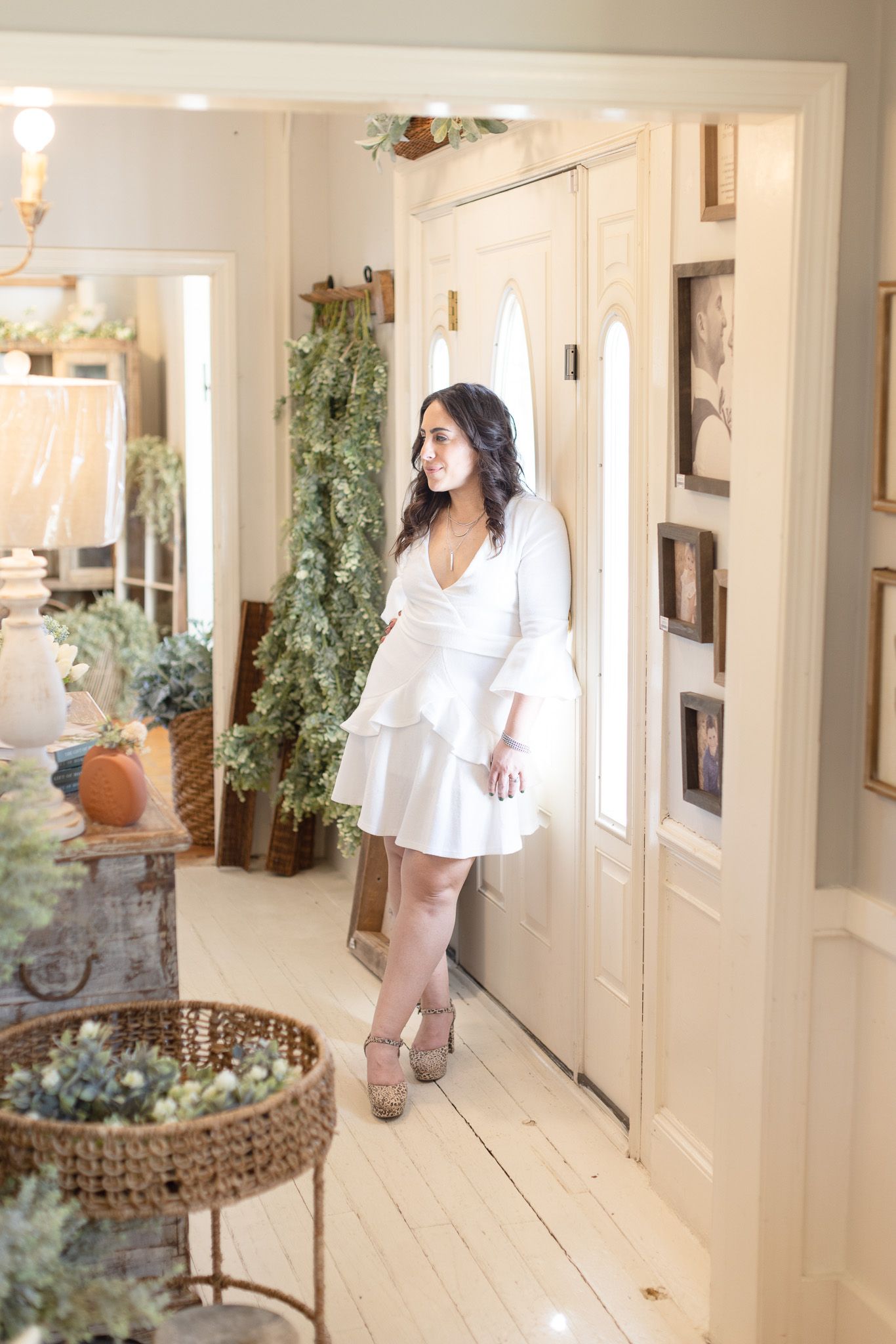 Interior lifestyle photos in white hallway with decorative baskets and potted plants.