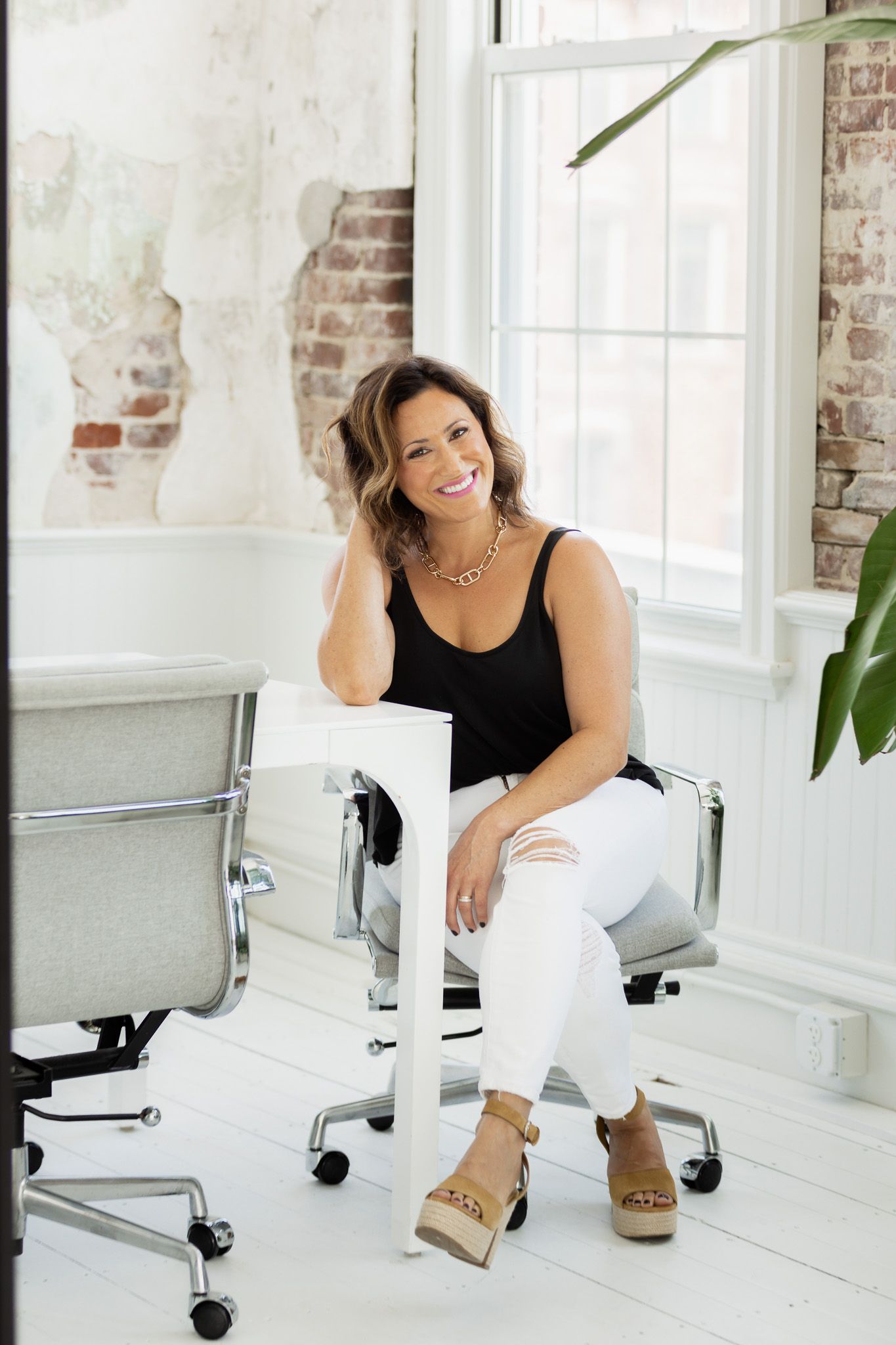 Series of casual poses on office chair showing relaxed business attire.
