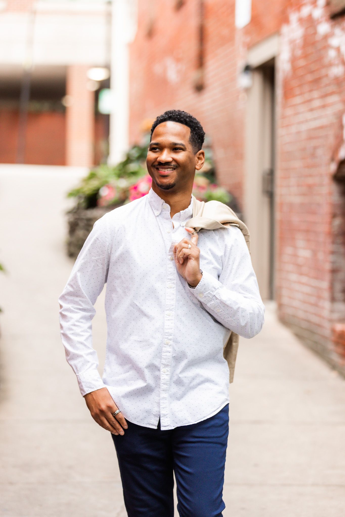 Casual outdoor photo shoot featuring white button-down shirt and navy pants.