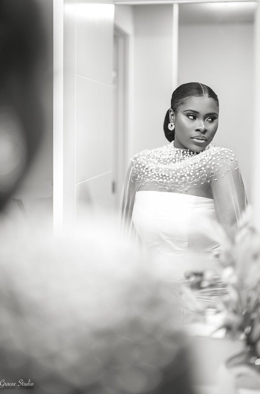 A black and white image of a bride in her bridal suit.
