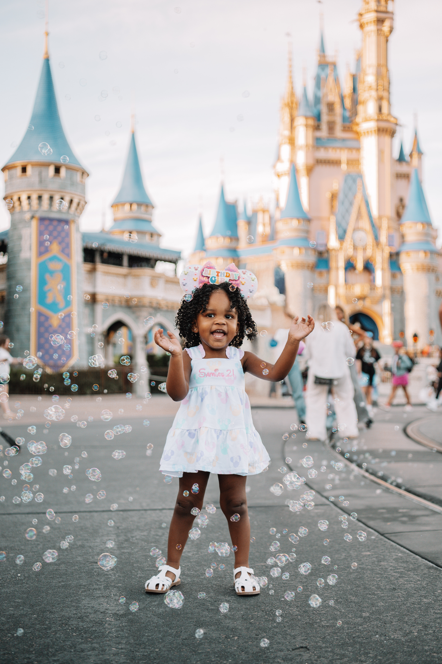 A joyful scene with bubbles floating in front of Cinderella Castle at Disney World.
