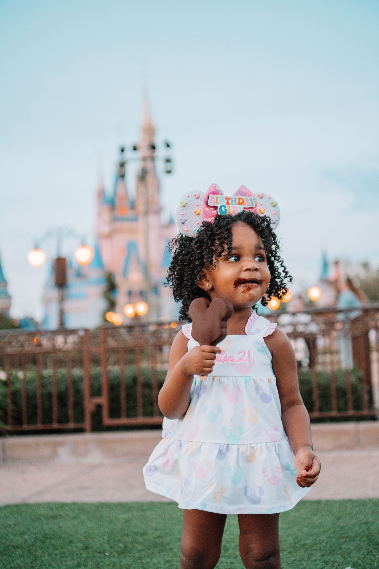 A magical evening photoshoot in front of illuminated Disney castle.
