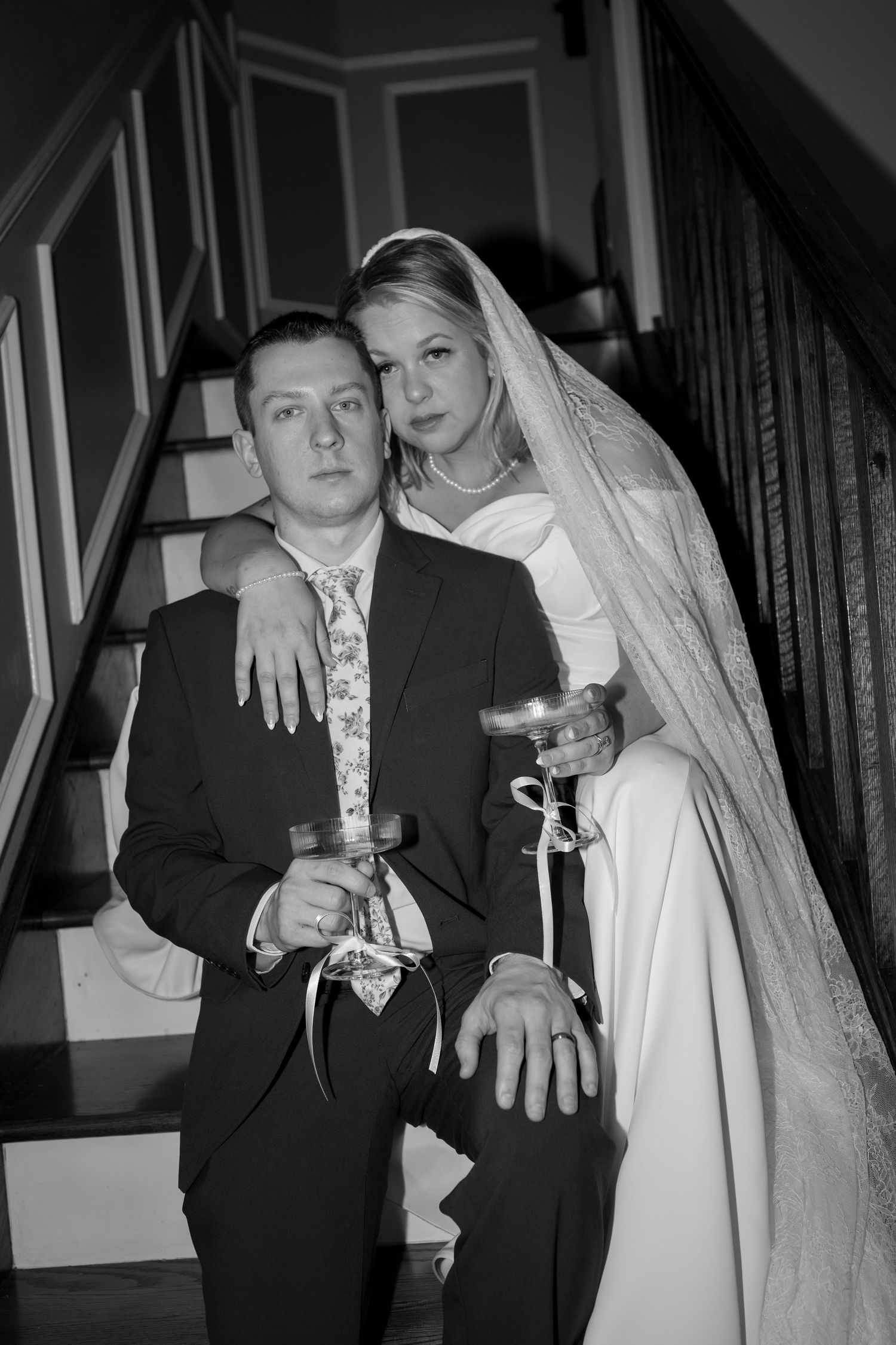 Close-up shots of wedding rings and champagne glasses in black and white.