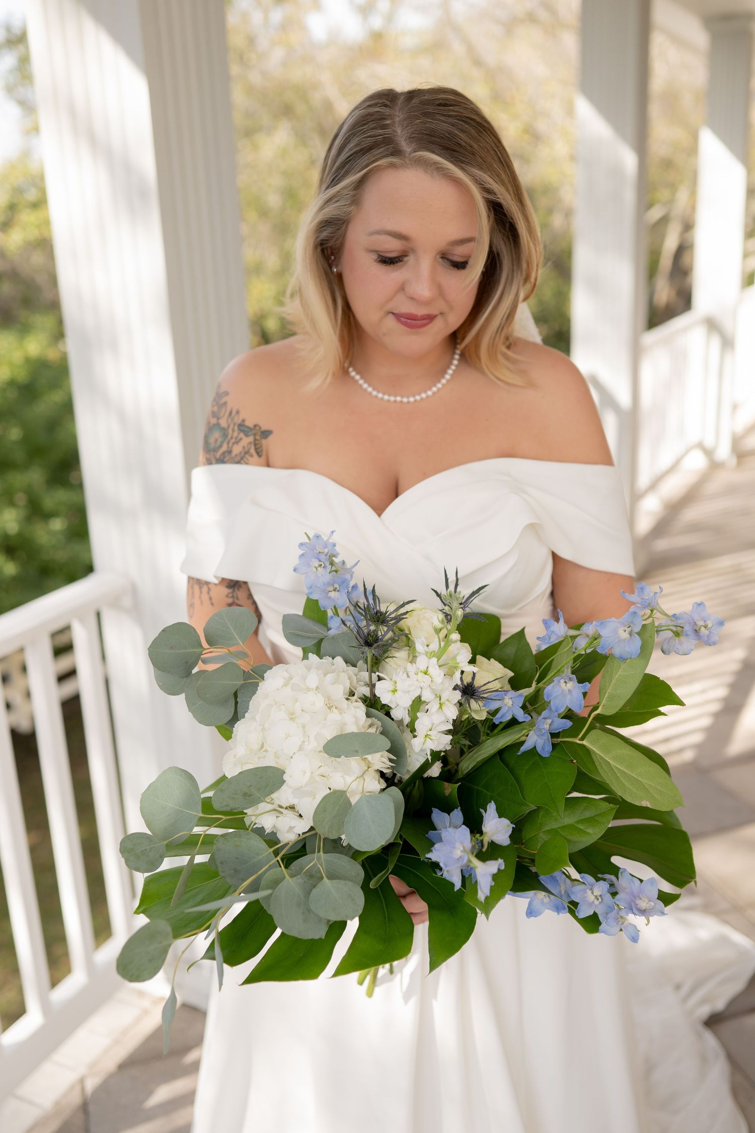 Wedding celebration with guests in navy blue and floral dresses outdoors.