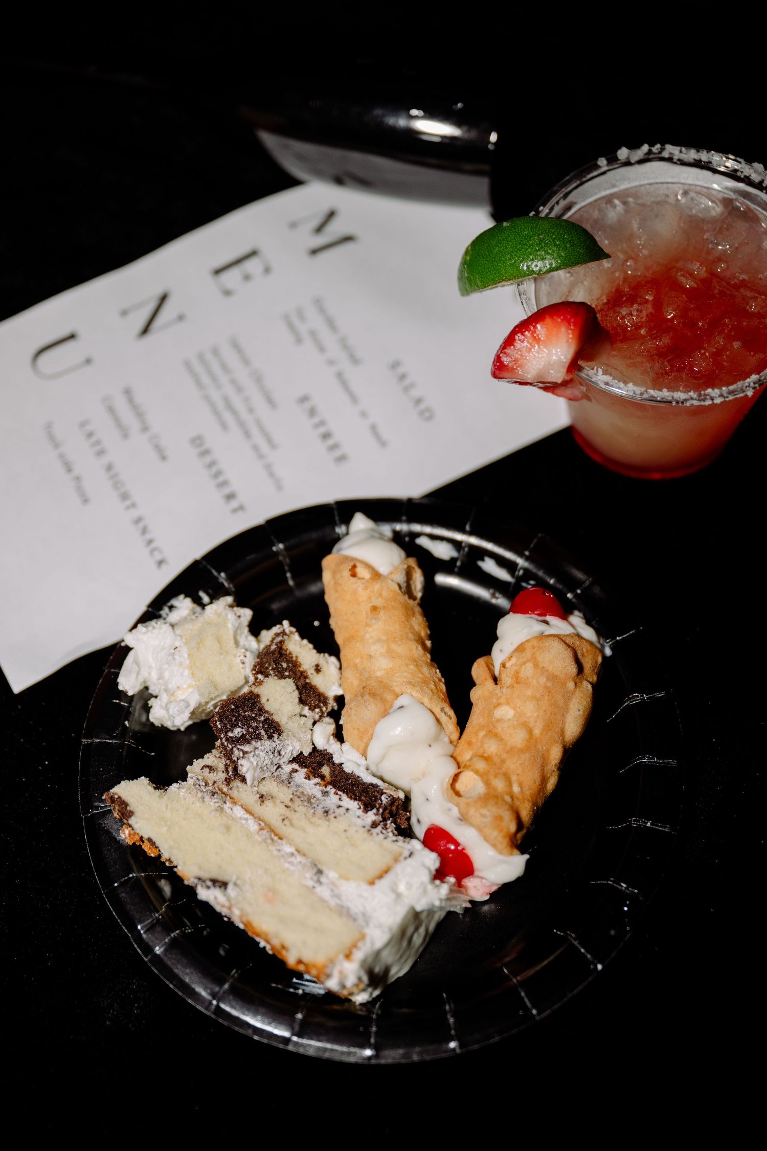 Wedding dessert plates with cake, cookies and strawberry garnishes on display.