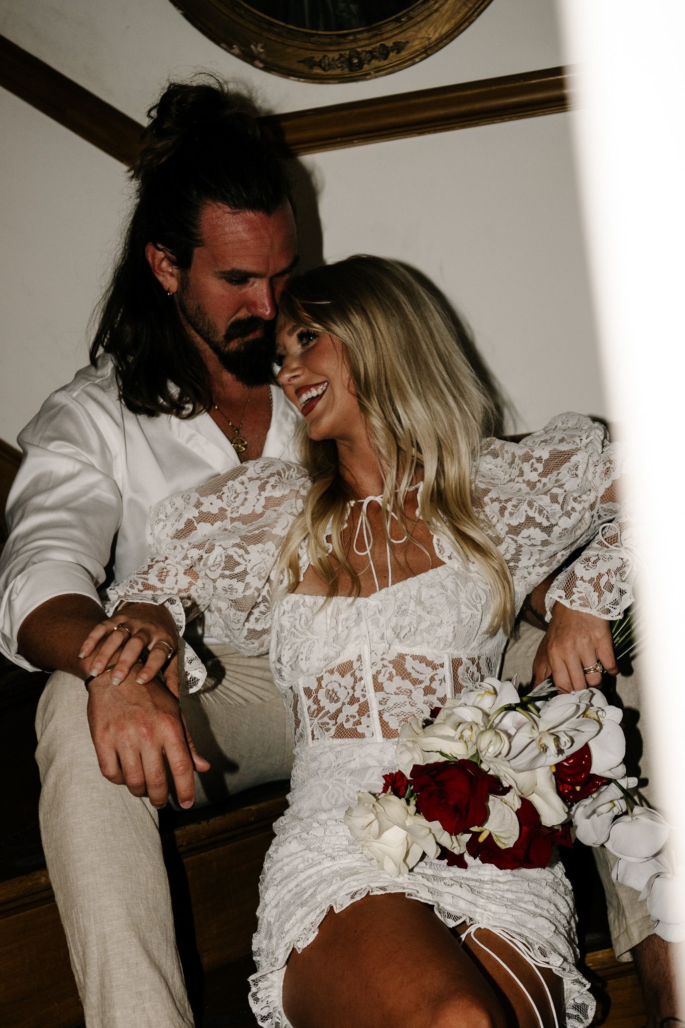 Intimate wedding moments captured indoors with couple in relaxed formal wear.