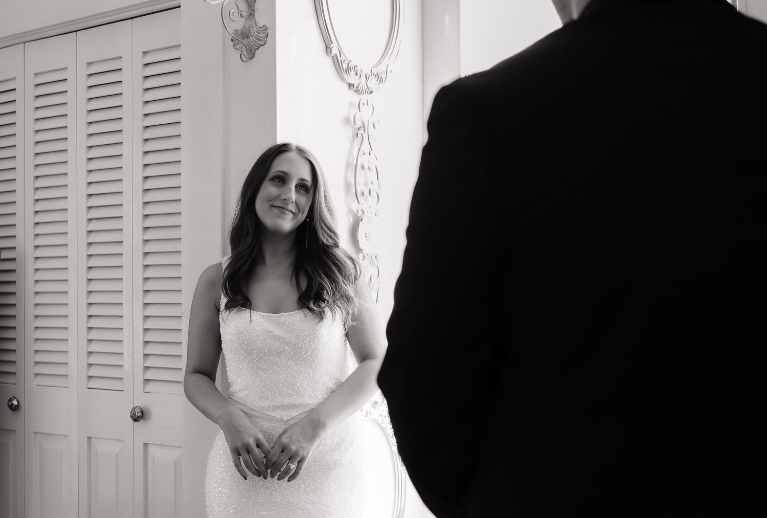 A series of black and white wedding photos showing brides in elegant white gowns standing in different poses.
