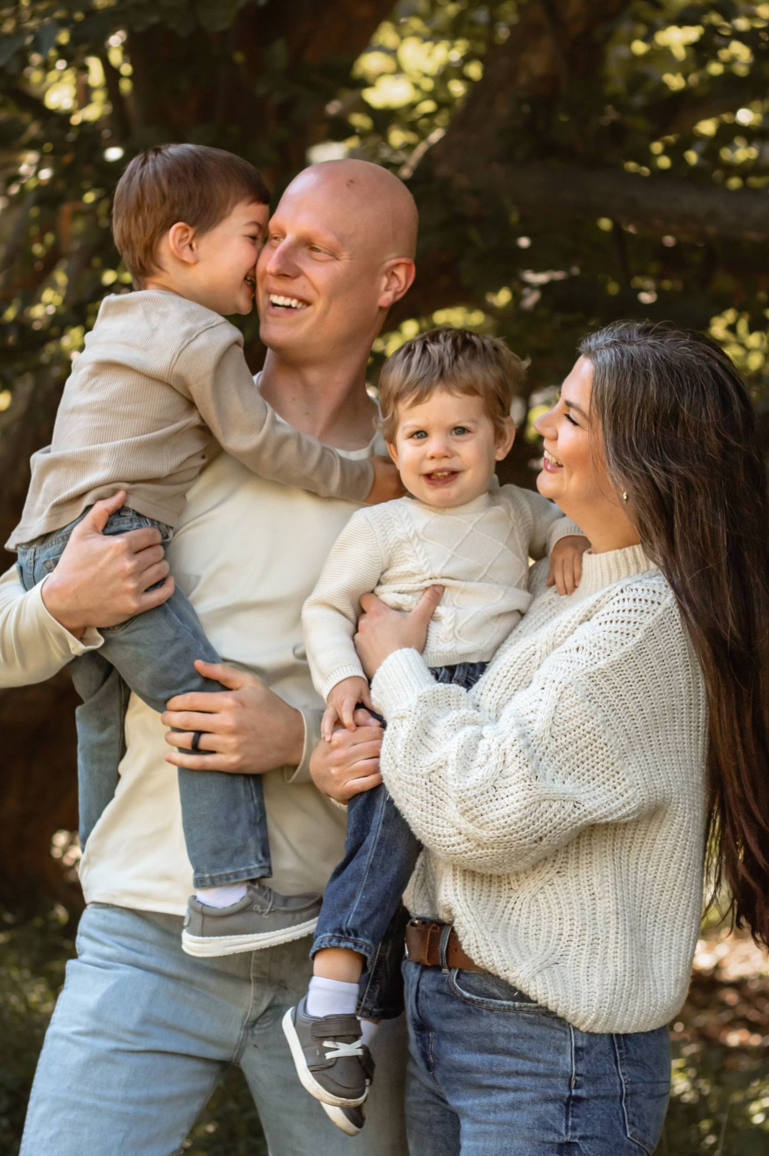 A joyful family moment outdoors with everyone wearing cozy sweaters and sharing laughs.