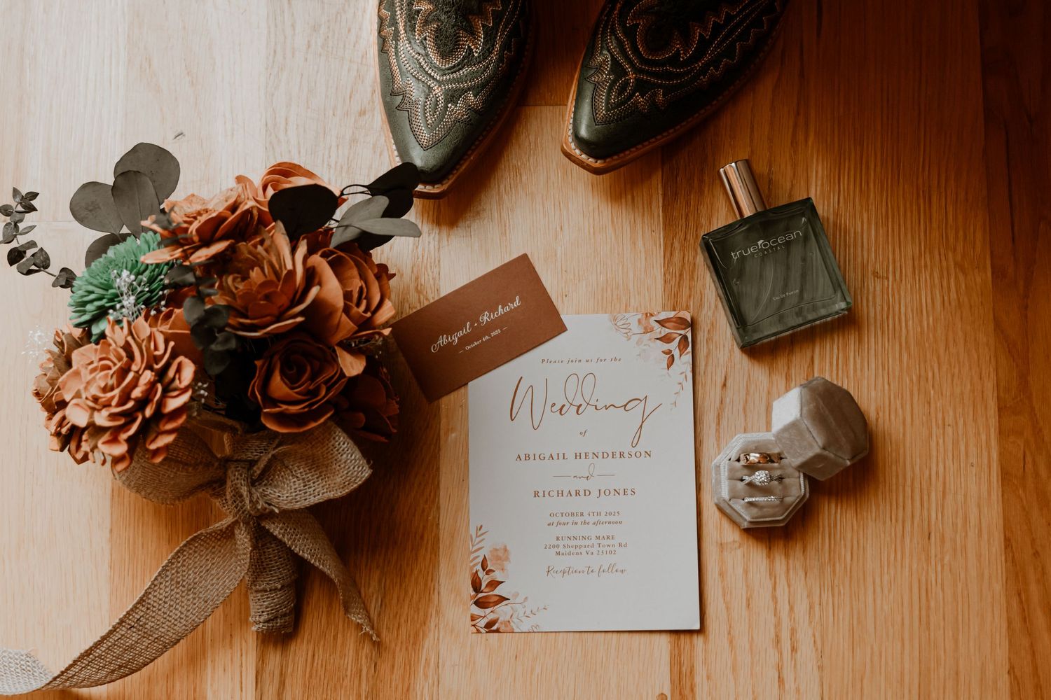 Wedding details including rings, shoes, and invitations arranged on wooden surface.