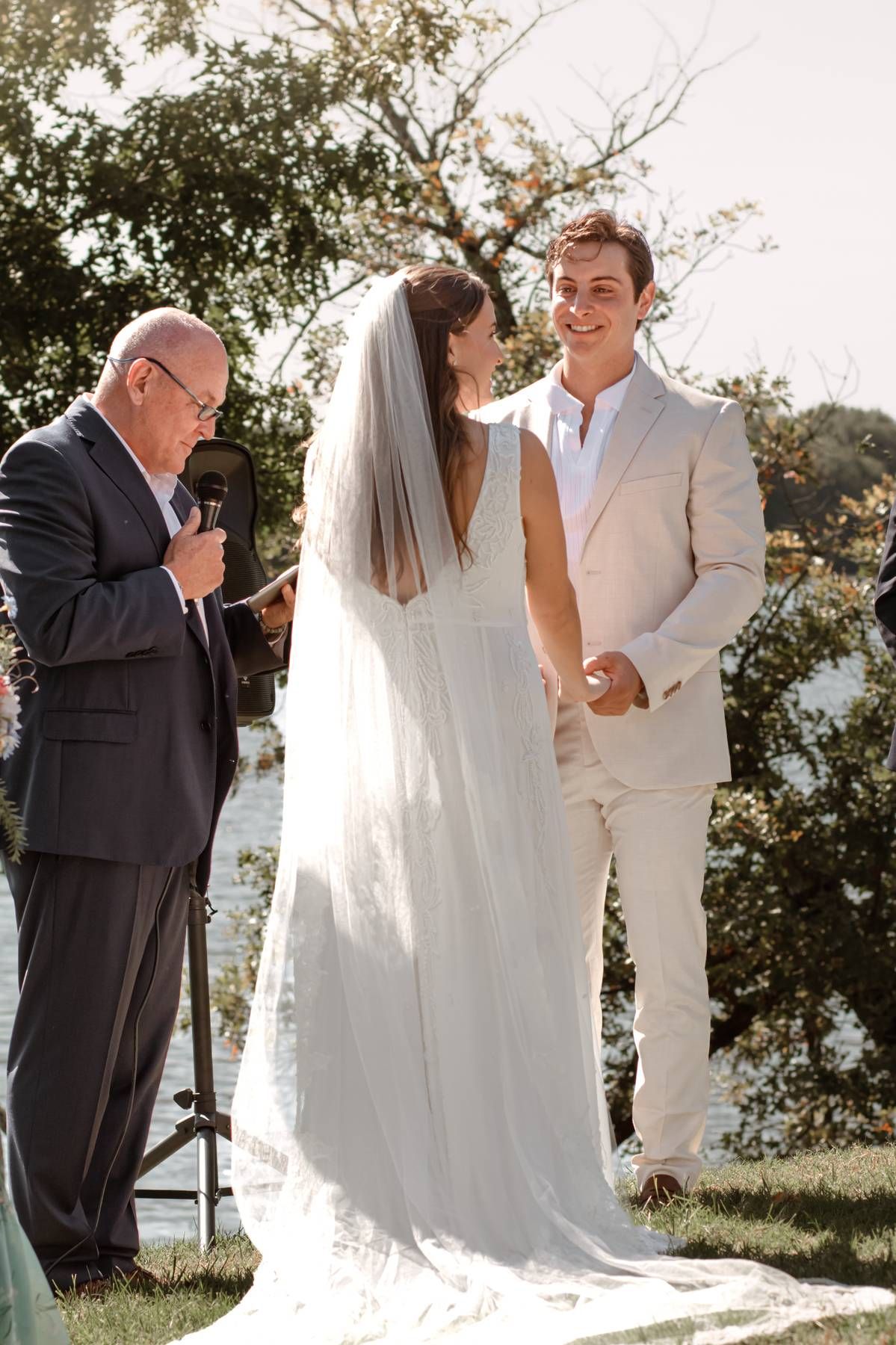 Candid wedding ceremony photos capturing reactions and emotions during vows by the waterfront.