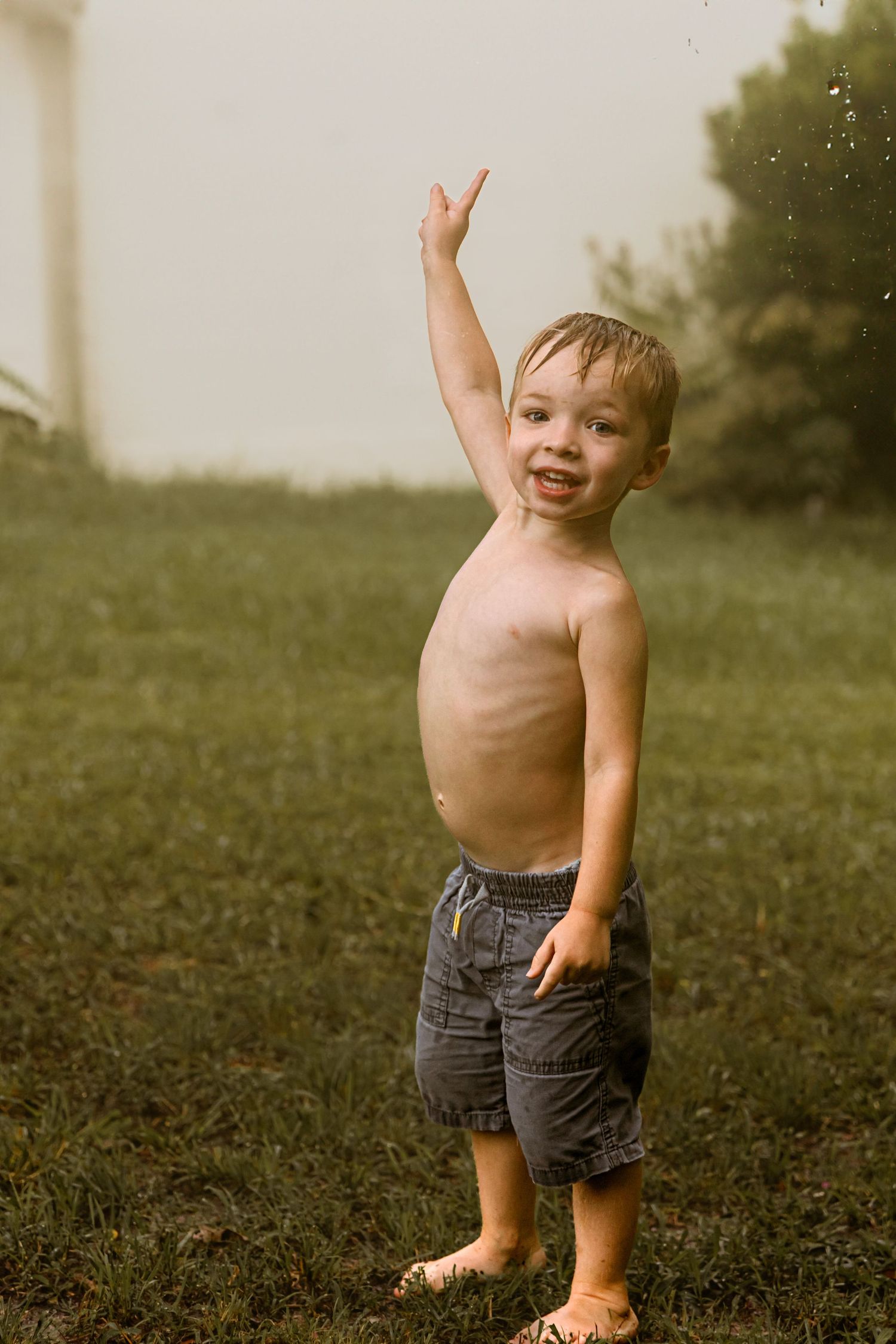 Sequence of a toddler playing and dancing joyfully in a grassy field.