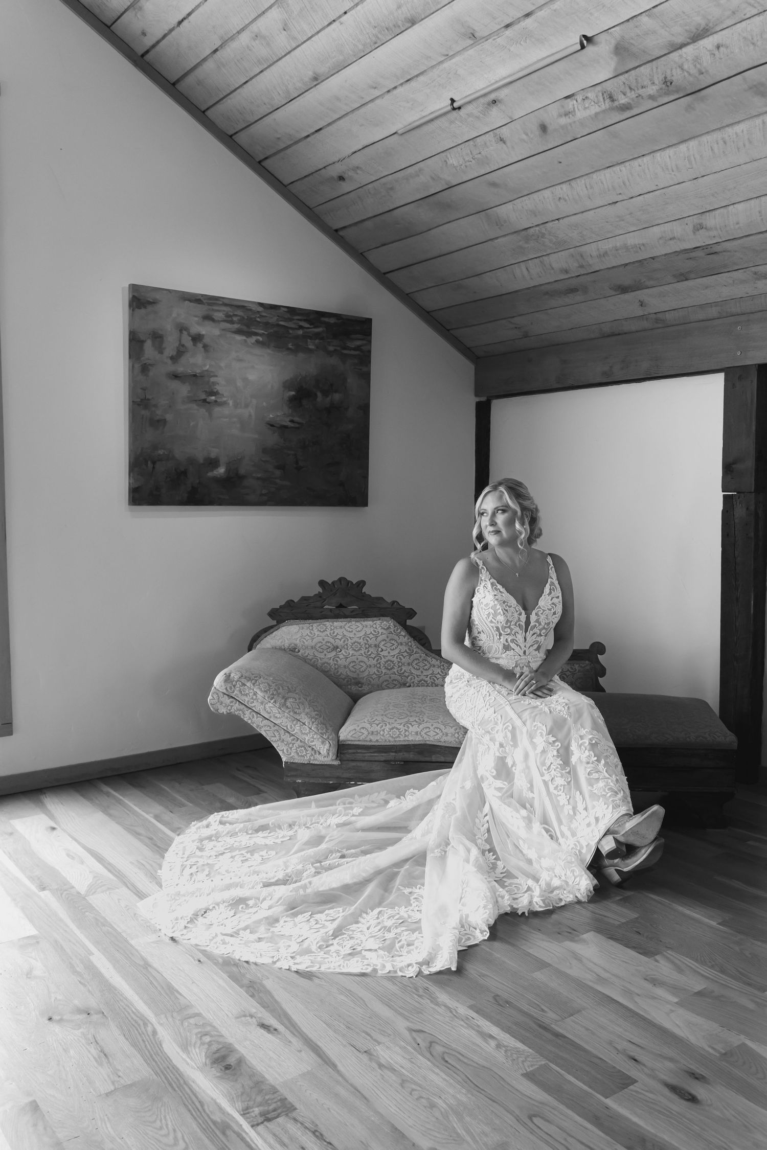 Artistic black and white bridal portraits on wooden floor showing movement and elegance.