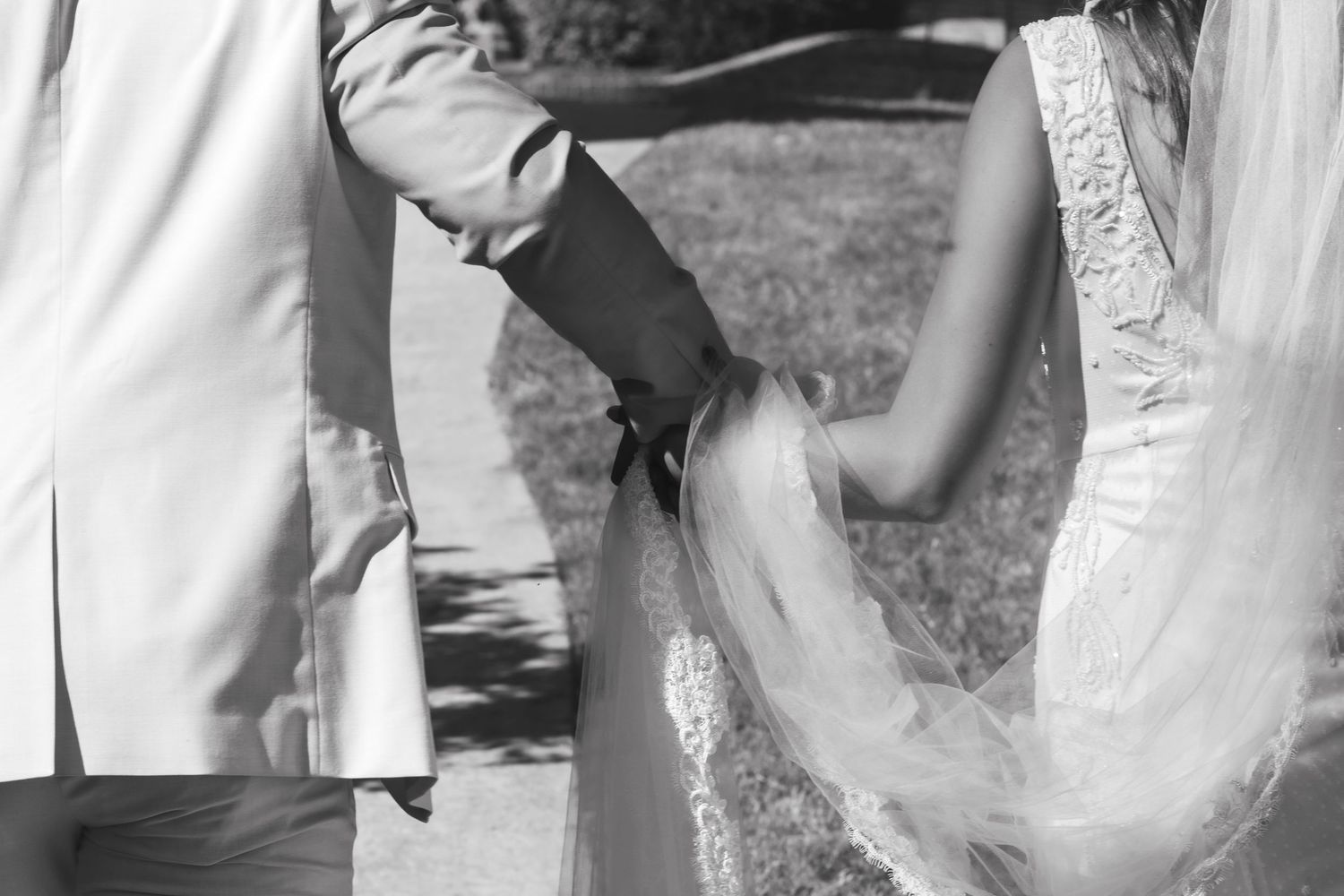 Romantic wedding moments captured in bright sunlight with flowing veil.