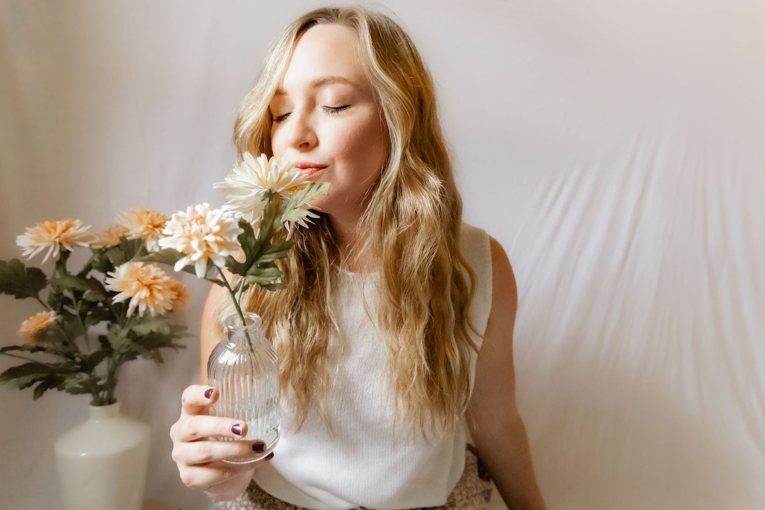 Ethereal photoshoot with flowers and soft natural lighting creating a romantic atmosphere.