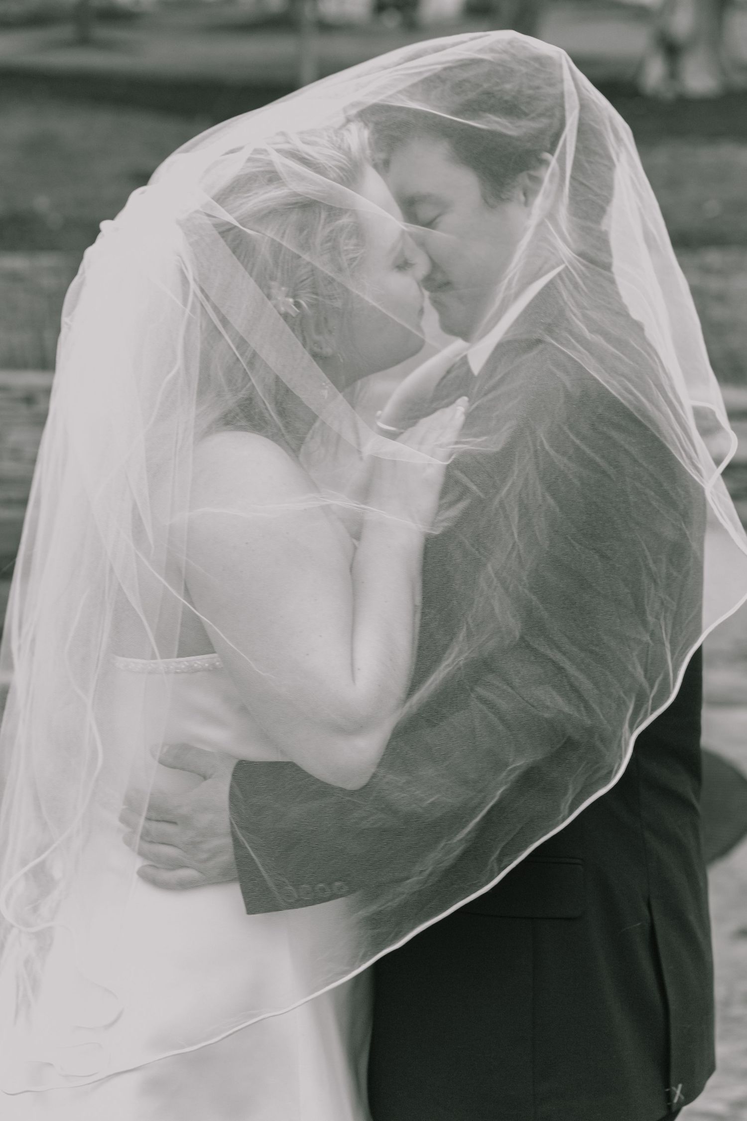 Romantic black and white photos show tender moments through a wedding veil.