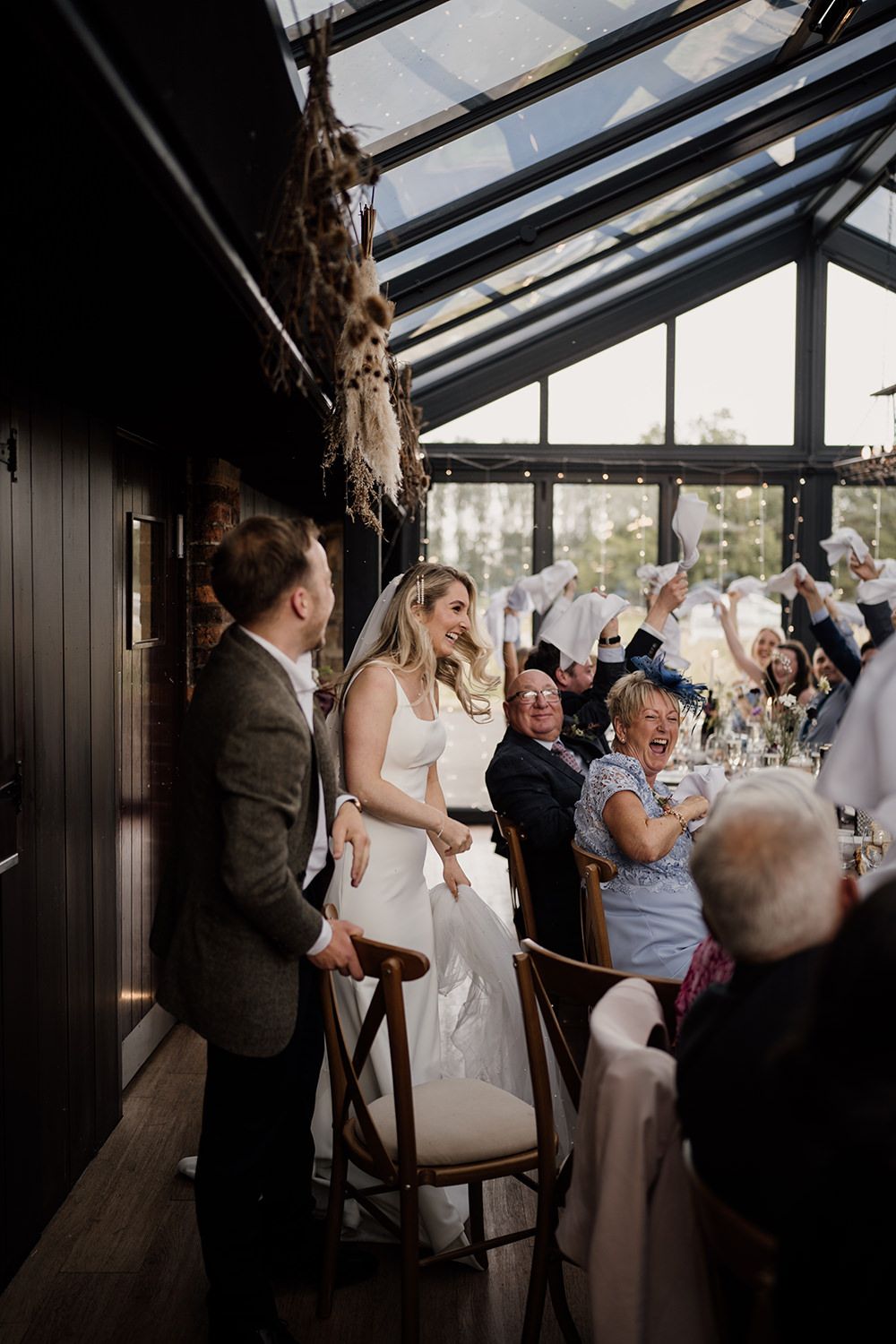 Bride and Groom sitting down after being announced into their wedding room at the Hovels Harewood.