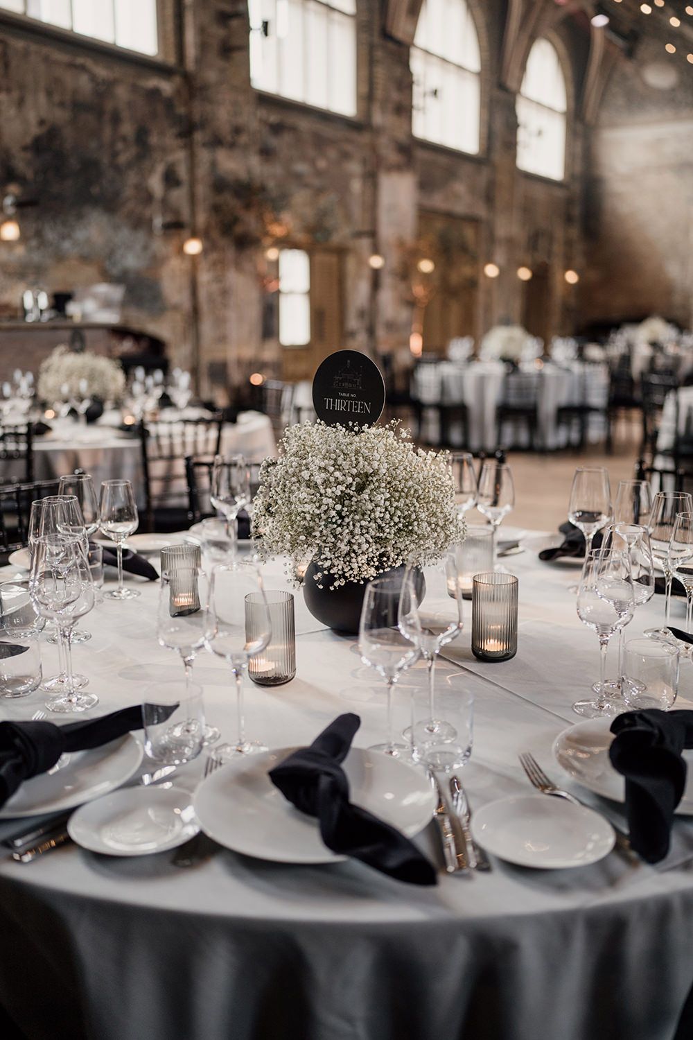 Wedding reception tables styled with monochrome colours at Battersea Arts Centre.