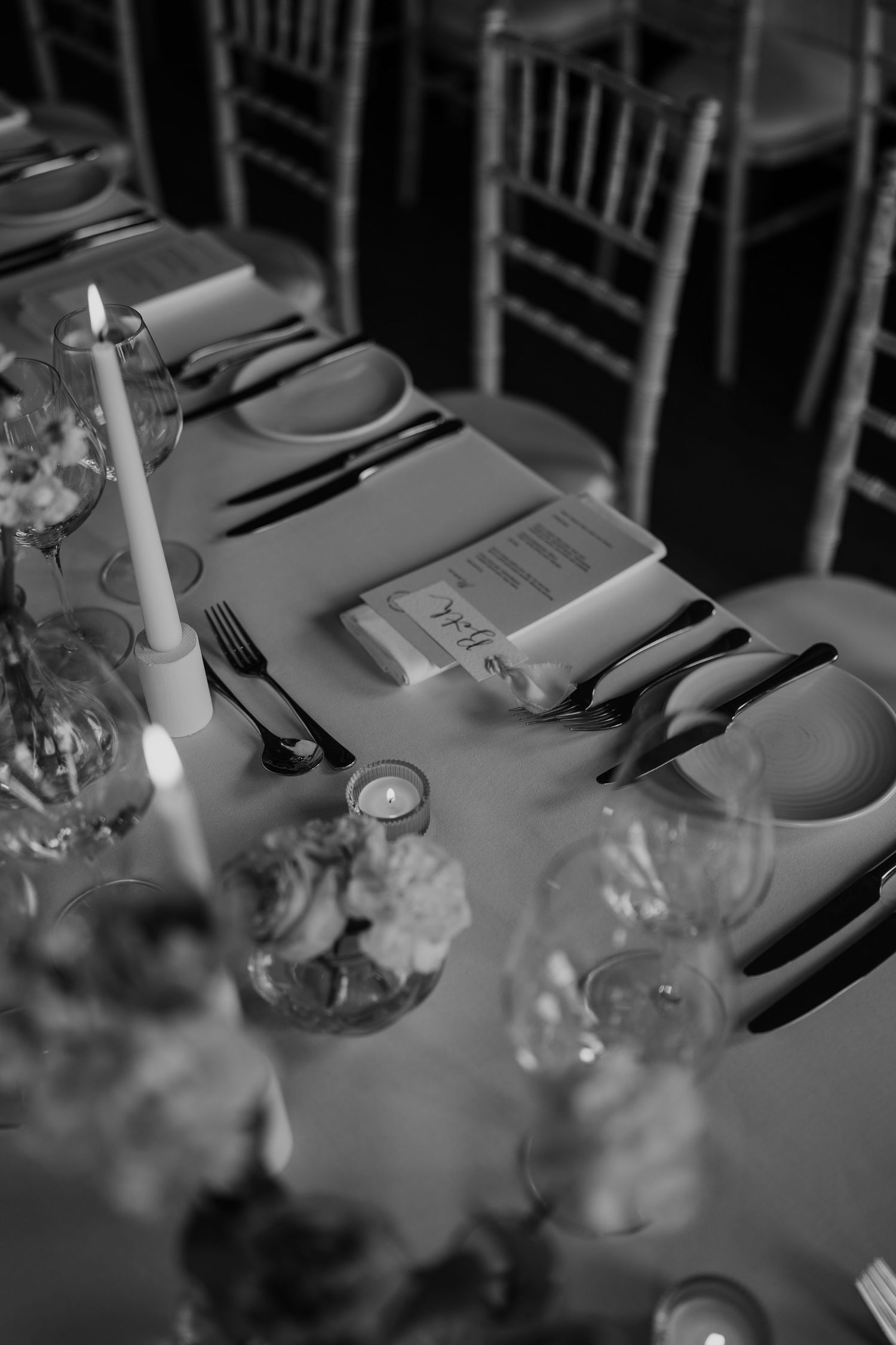 Detail photograph of wedding stationery styled on the reception table.