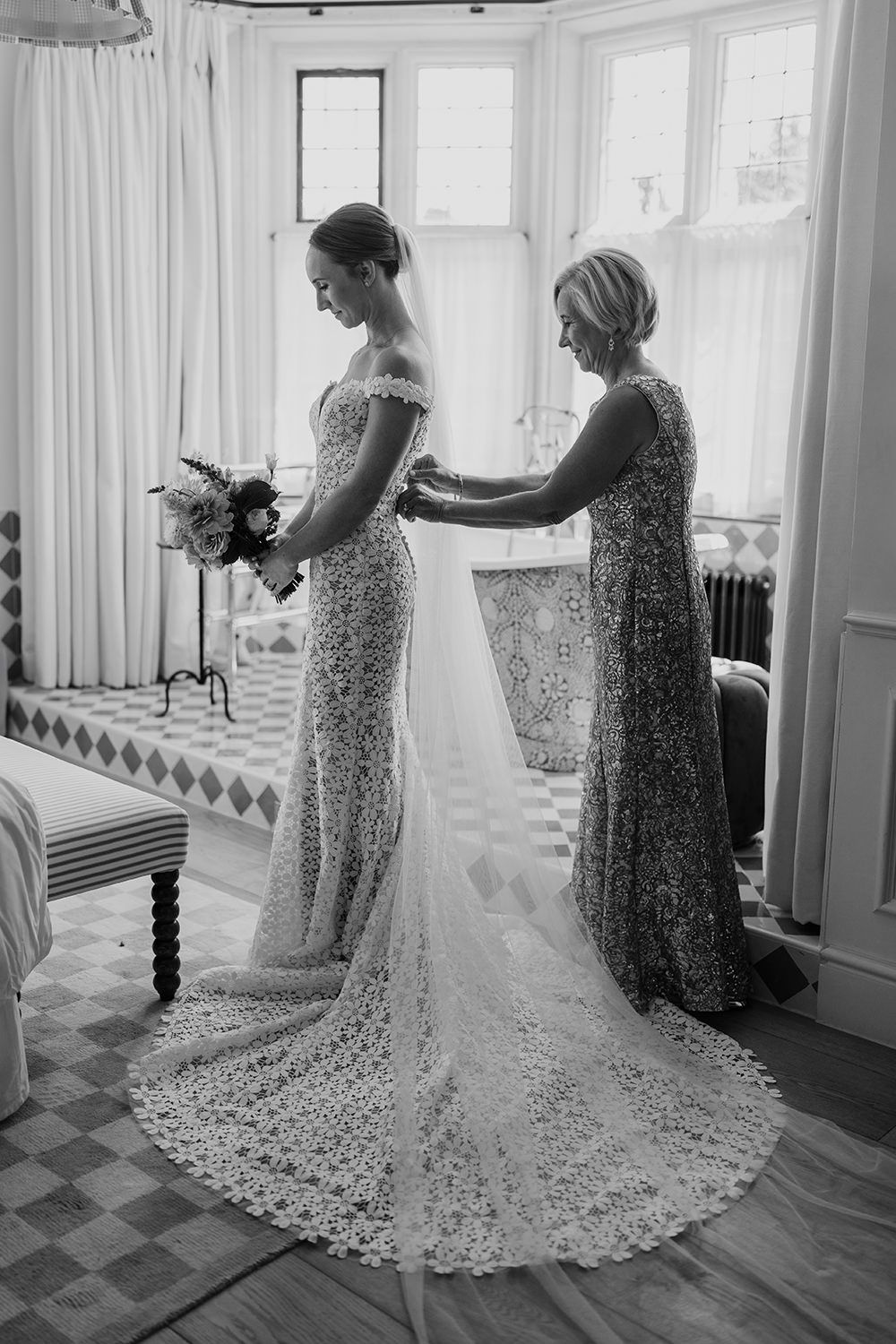 Mother of the bride fastening her daughter in her wedding dress at Kin House.