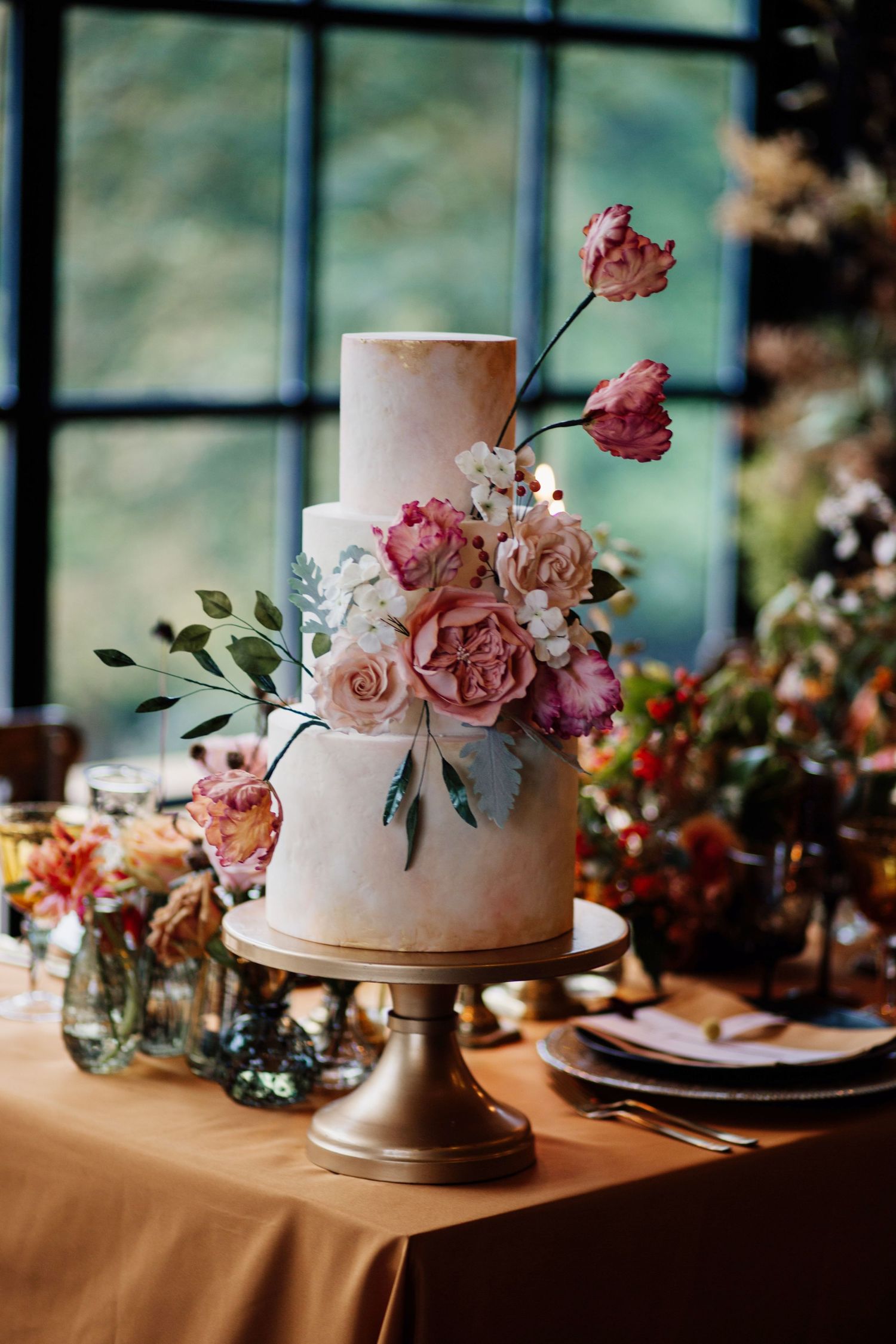 Wedding cake with hand made flowers on an autumnal table scape.