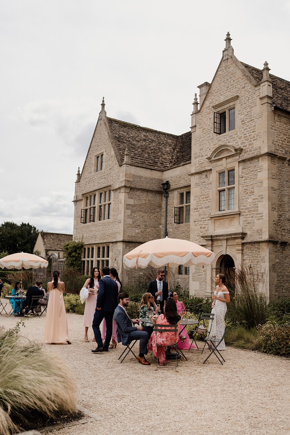 Candid wedding photography: guests enjoying cocktails on the lawn at Kin House.