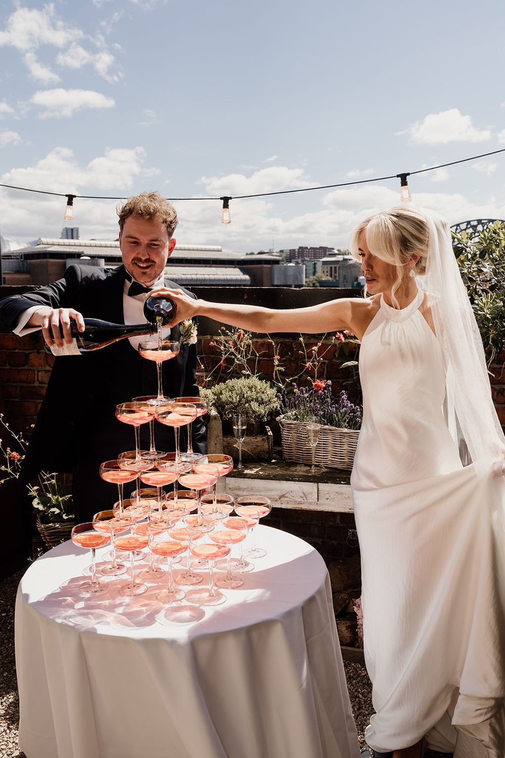 A cool take on a wedding day champagne tower aperol spritz on the rooftop terrace.