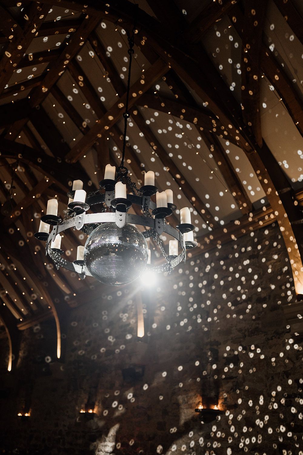 Disco ball shining light off the wooden beams at Healey Barn.