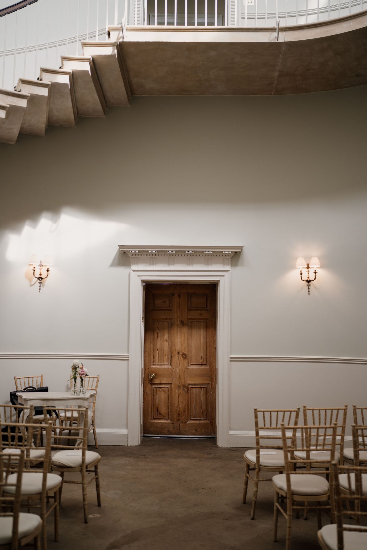Empty ceremony room at middleton lodge with a wooden door in the center.