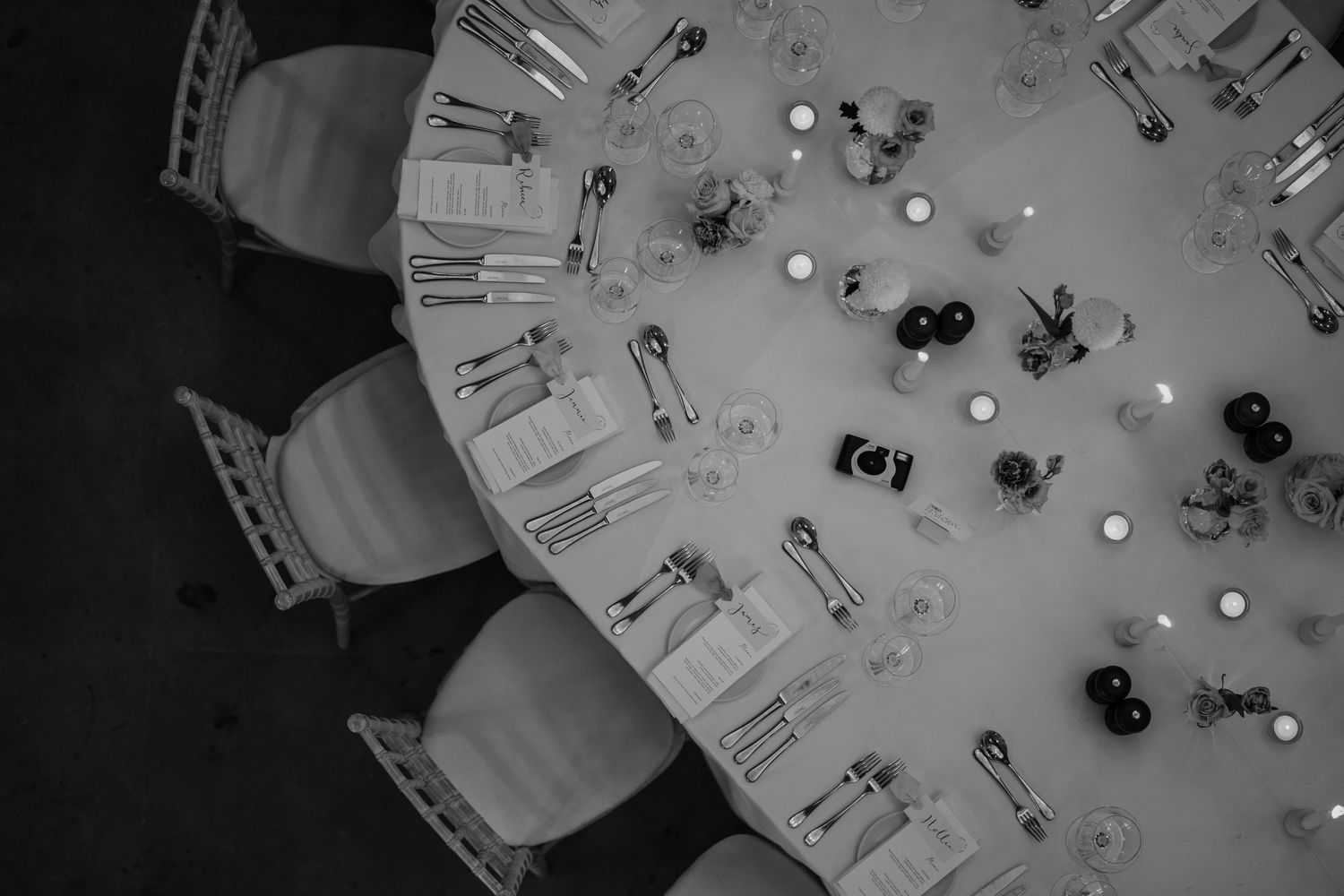 Black and white image of a wedding table styled, photographed from above.