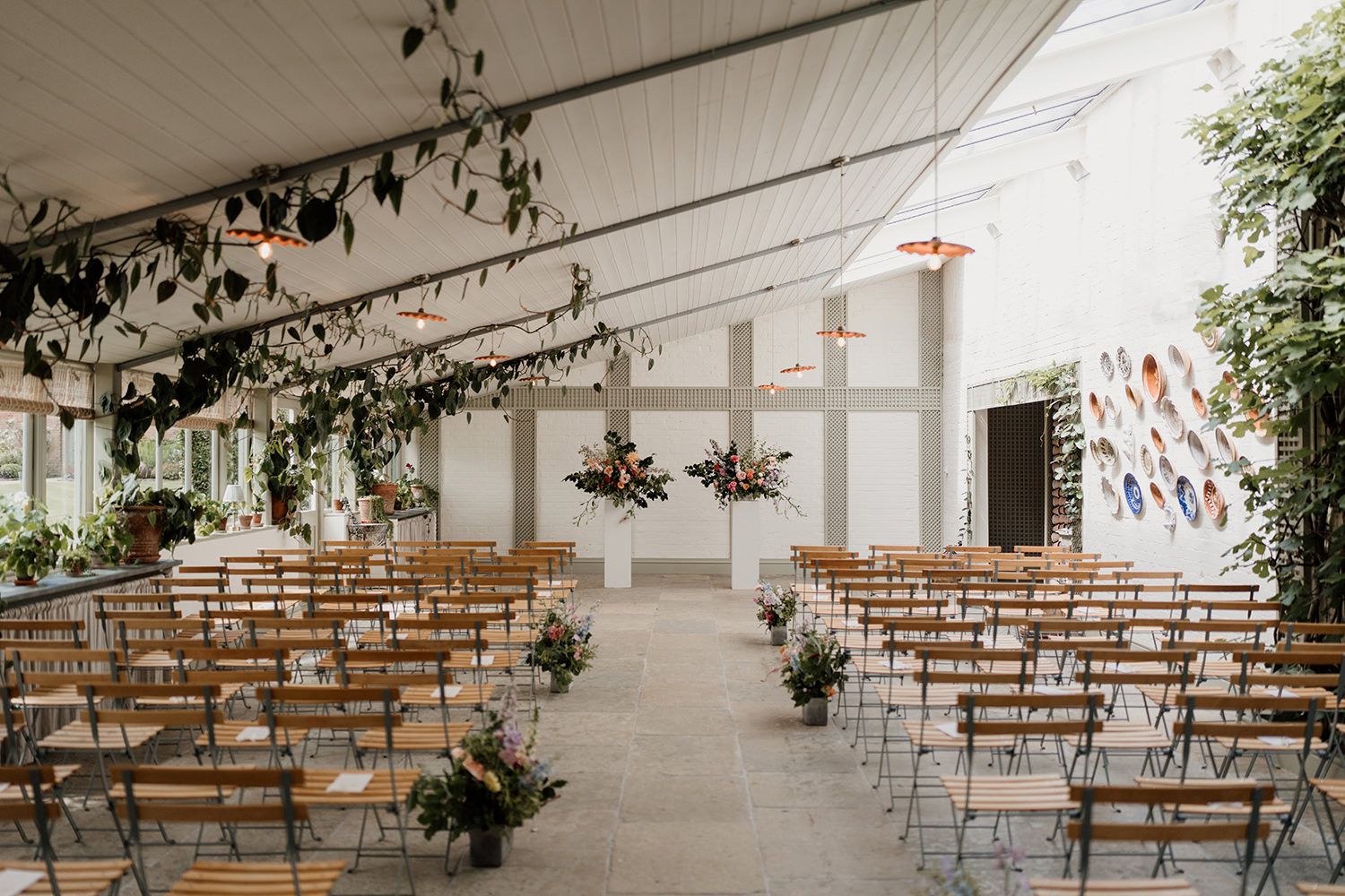 Photograph of the wedding ceremony with colourful flowers at The Garden Room, Kin House.