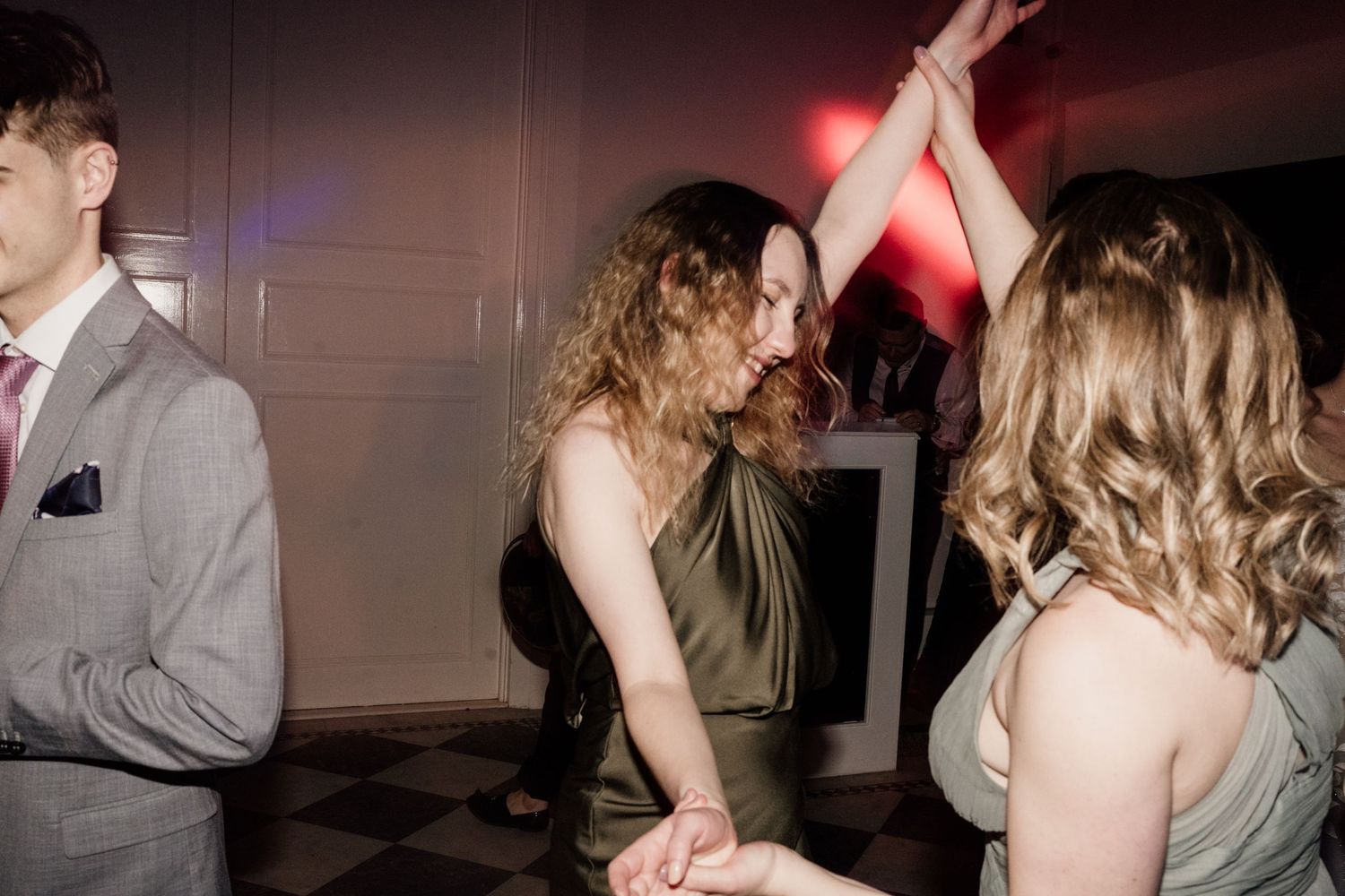 Bridesmaid dancing with friends at wedding party.