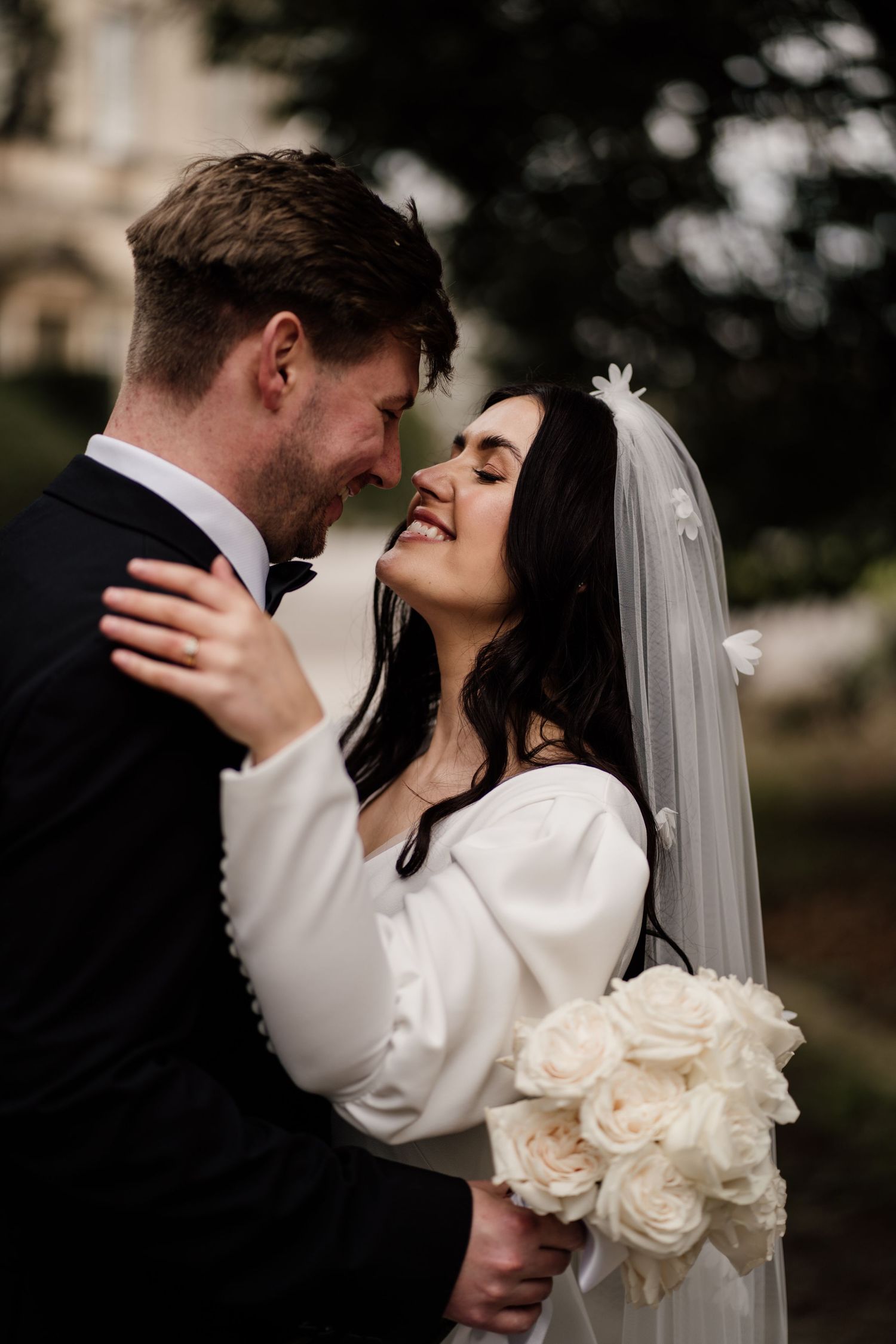 Bride and groom looking towards each other at Middleton Lodge Estate.