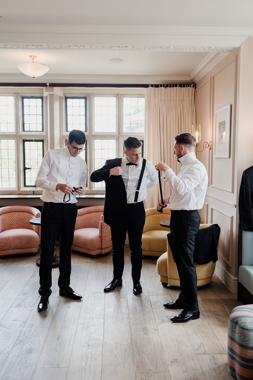 Groomsmen at The Fitz Bar in Kin House as they put on their wedding suits.