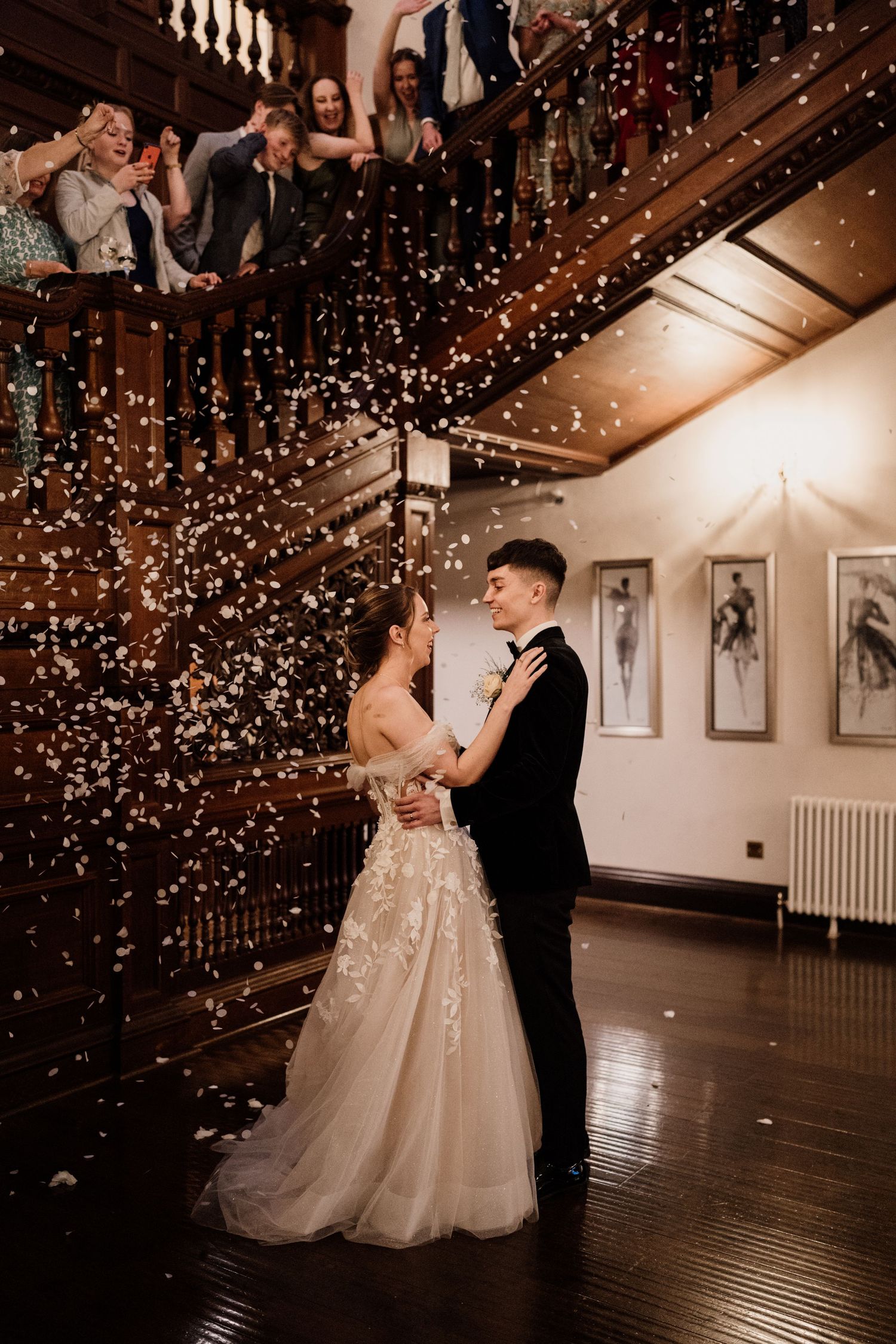 Bride and groom dancing while confetti falls around them during their first dance.