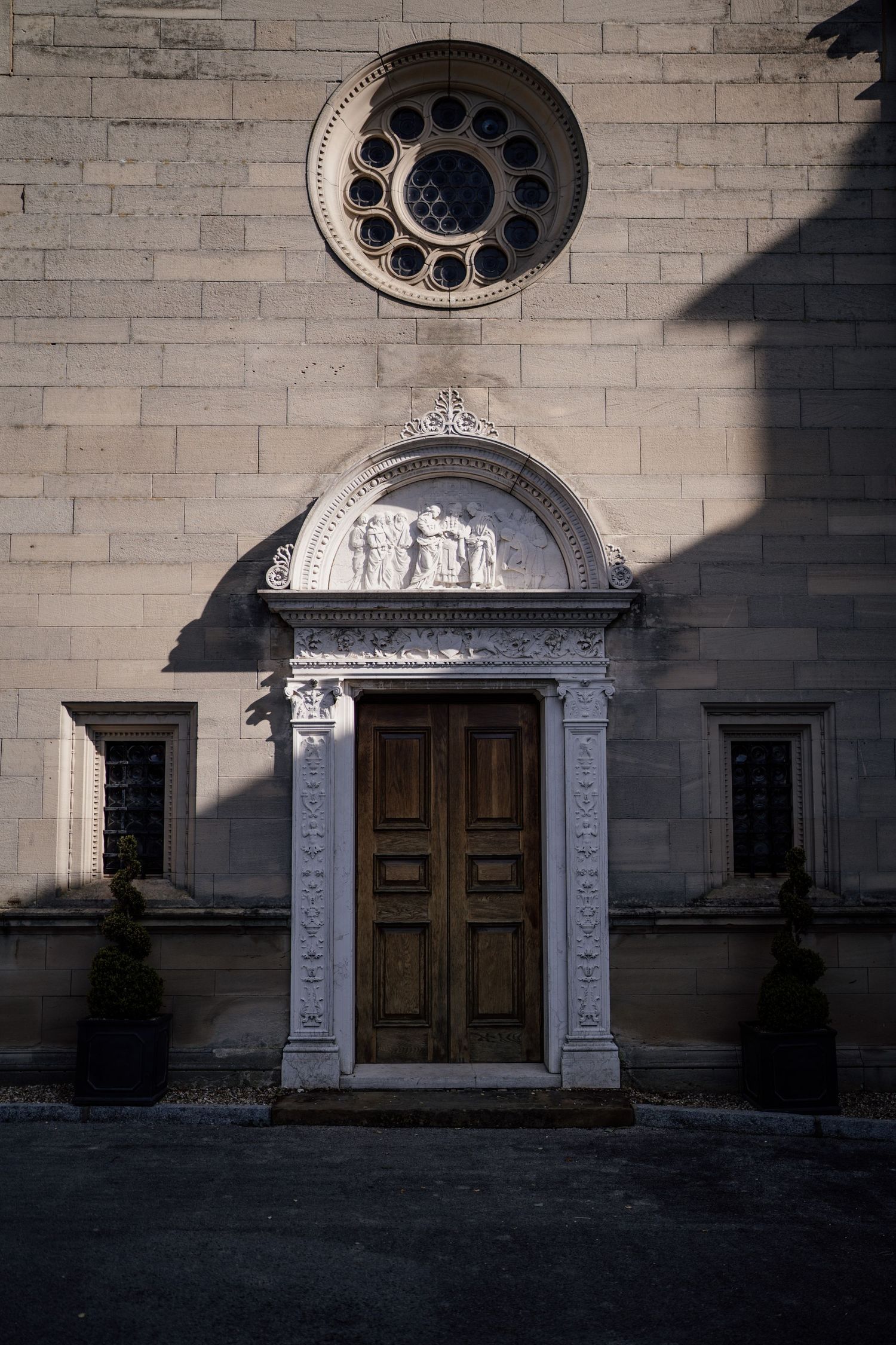 Detail of the side of Bourton Hall with the sun creating a shadow.