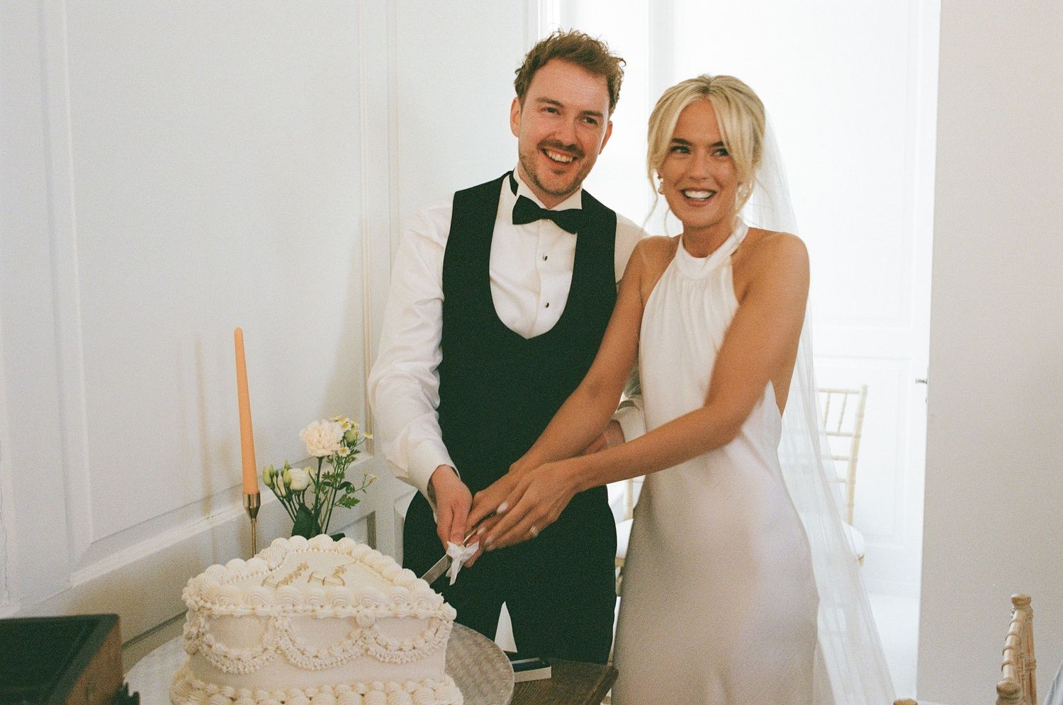 Bride and groom cutting their vintage wedding cake at The Secret Tower, captured by an editorial wedding photographer.