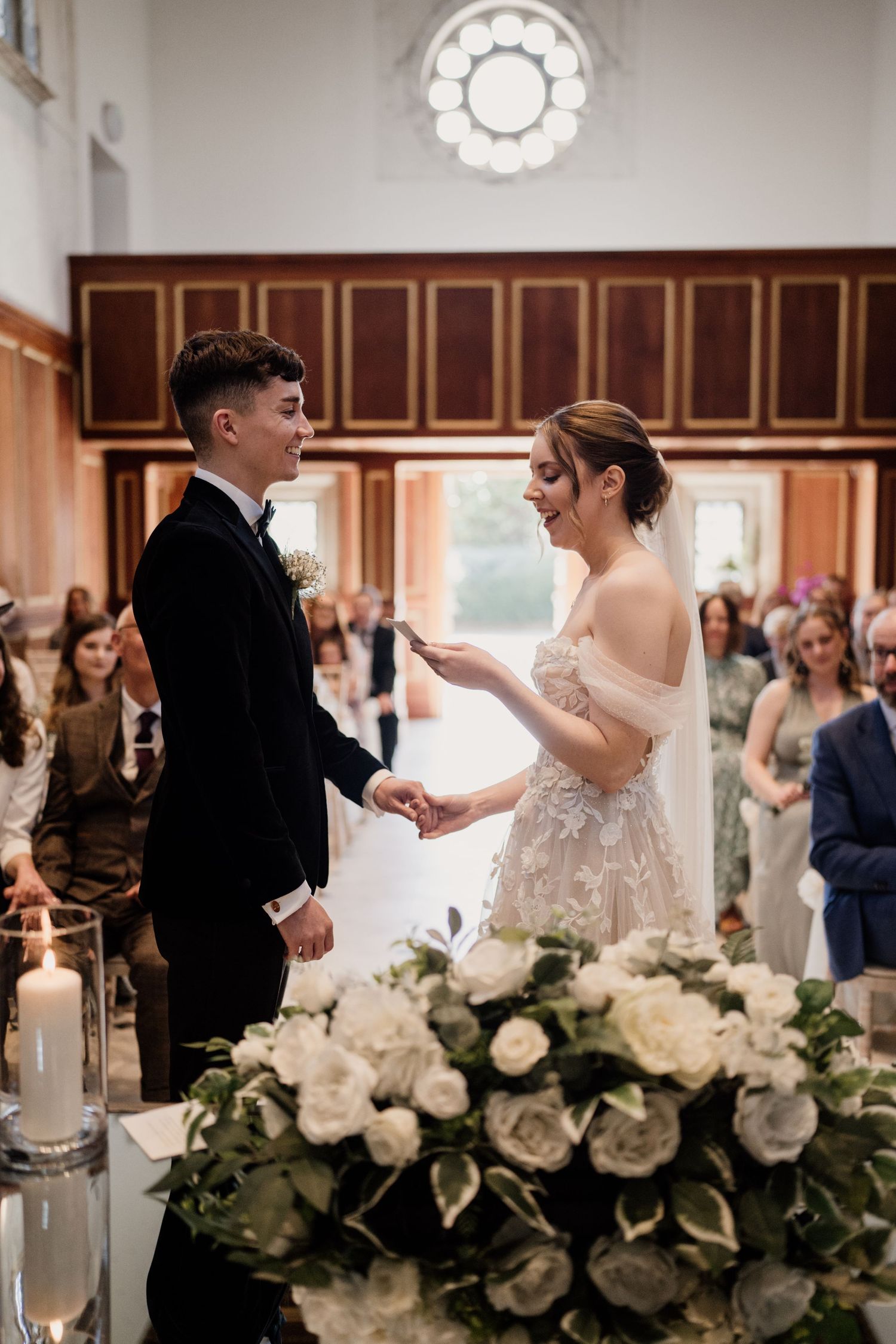 Couple getting married with the Boughton Hall ceremony room in the background.