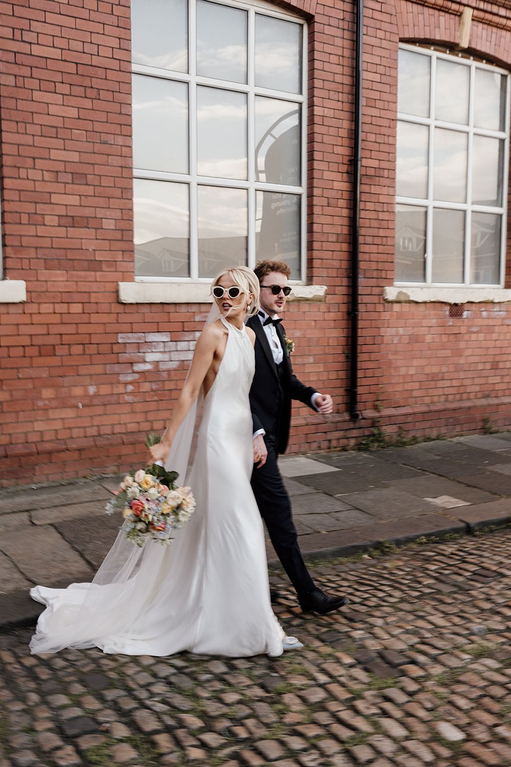 Candid wedding photography: Bride and groom in The Secret Tower's stylish grounds