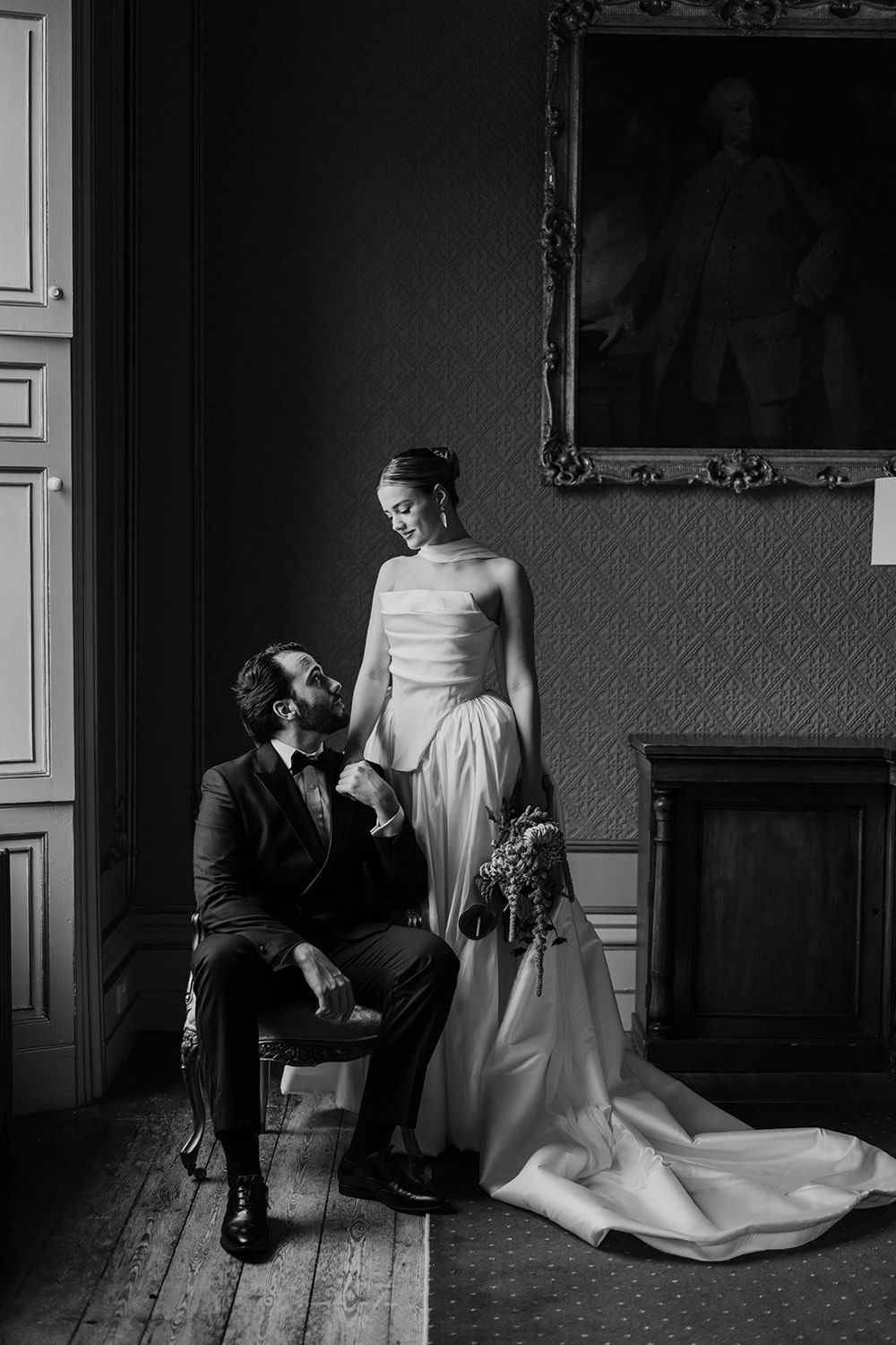 Editorial wedding portrait session: Bride and groom holding hands while looking towards each other.