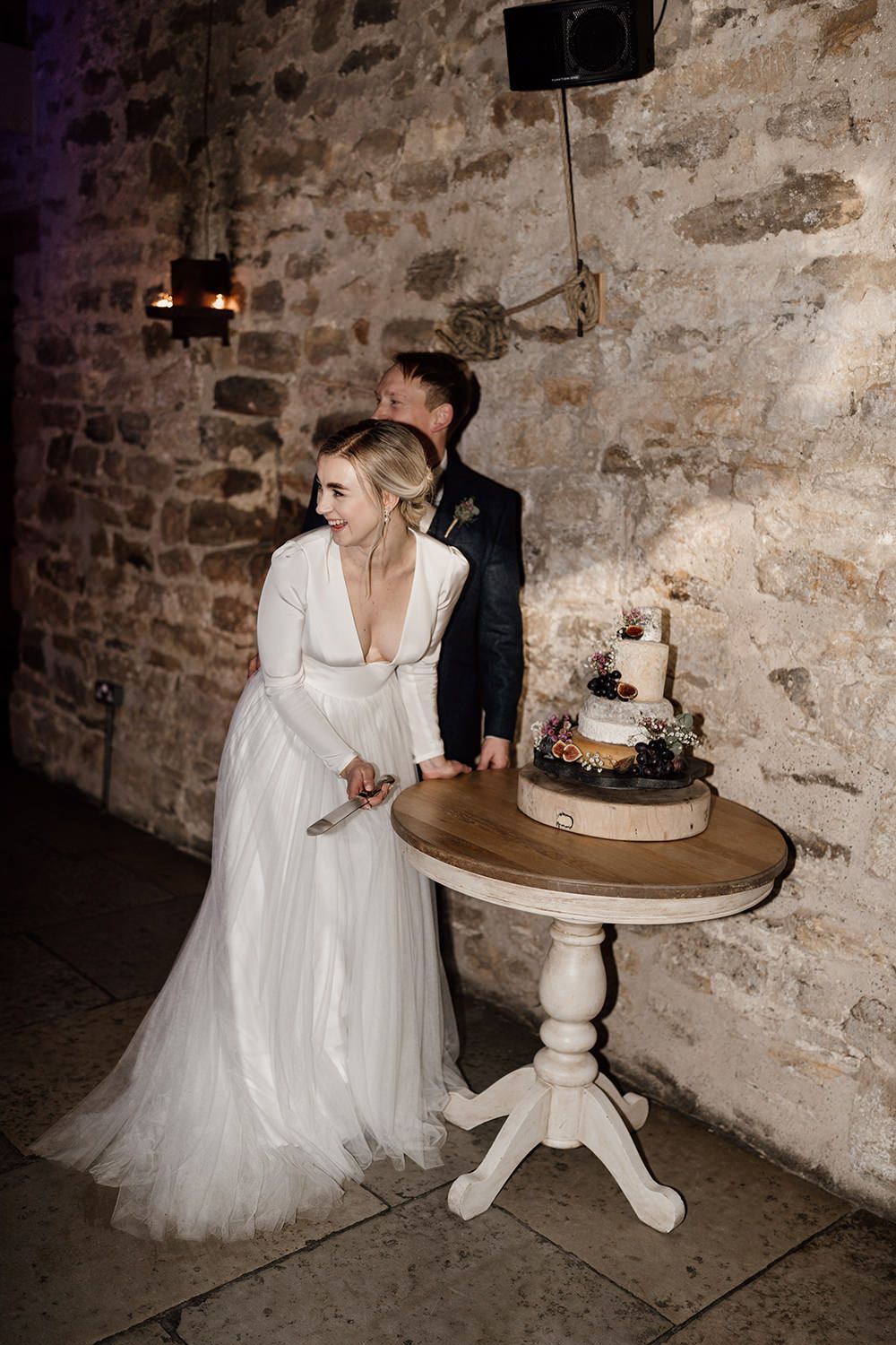 Bride and groom cutting their cheese cake at Healey Barn.