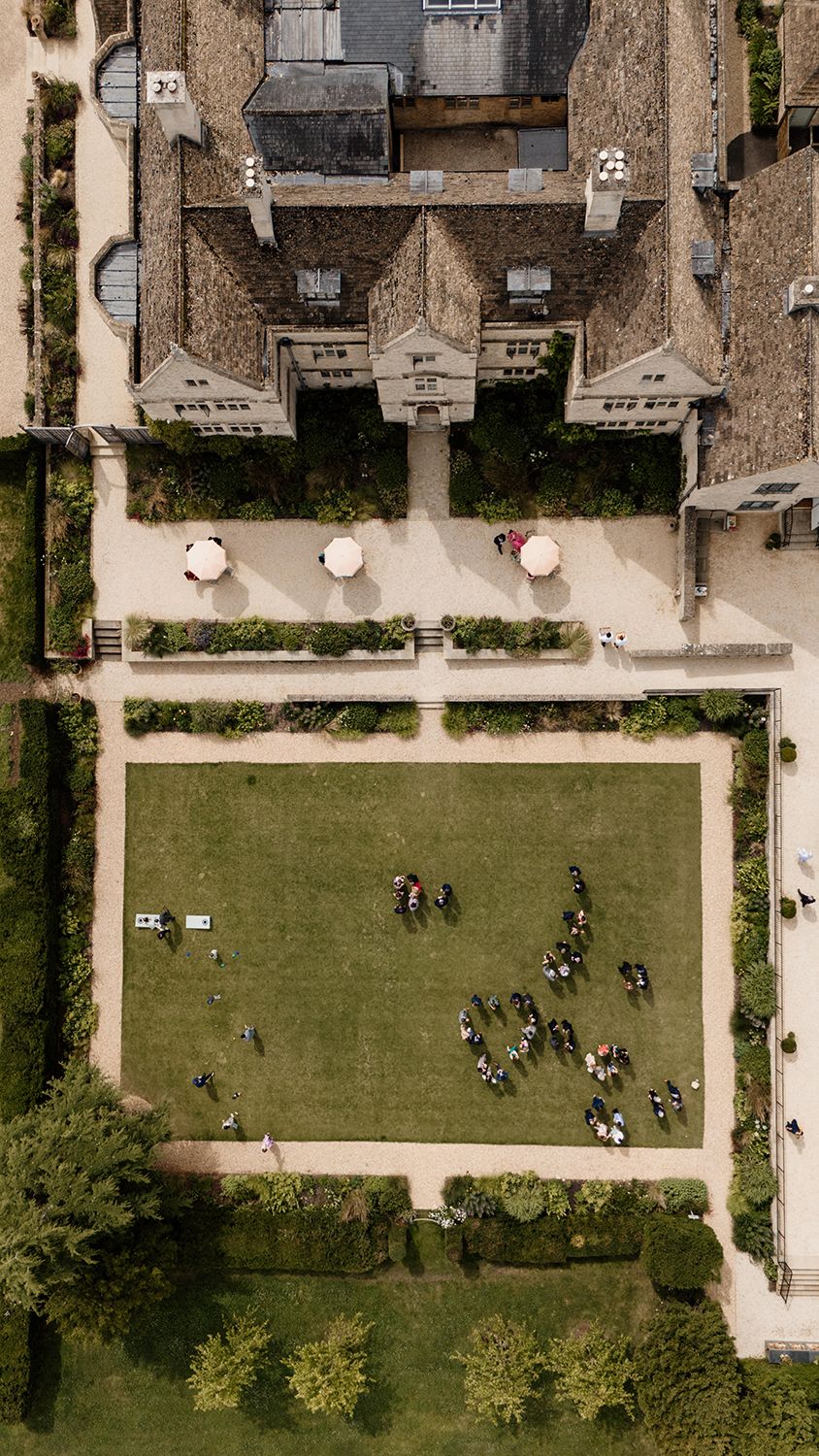 Aerial view of the intimate Kin House wedding reception, showcasing guests mingling on the lawn.