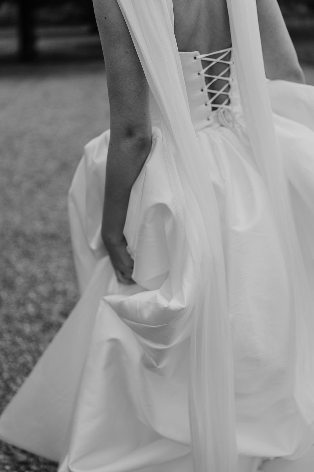 Bride picking up her custom made wedding dress, a detail of the fabric.