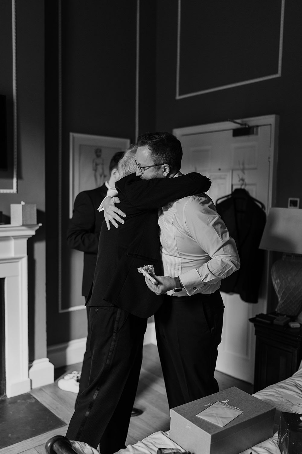 Groom hugging his dad as they get ready on their wedding morning at Middleton Lodge Estate.