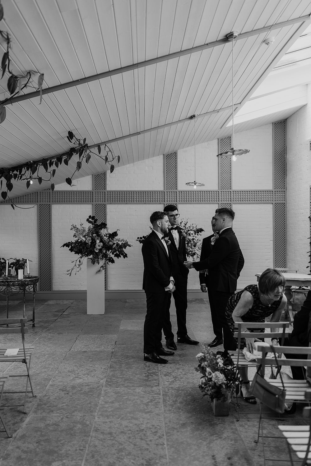 Groomsmen talking before the wedding ceremony in Black & White at Kin House.