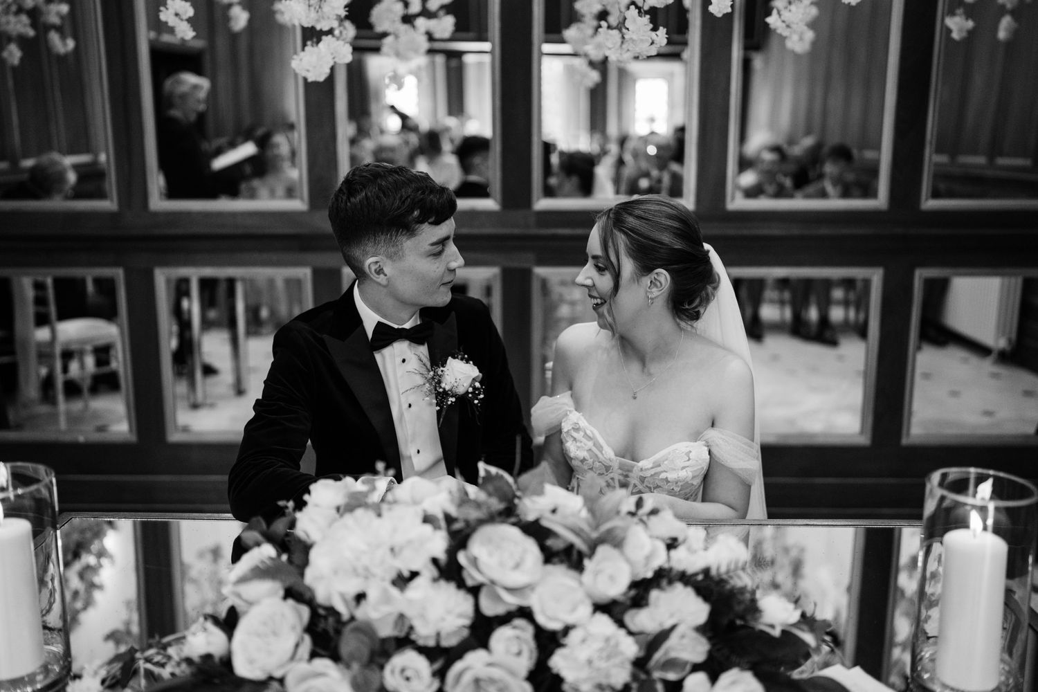 Couple signing forms on their wedding day.